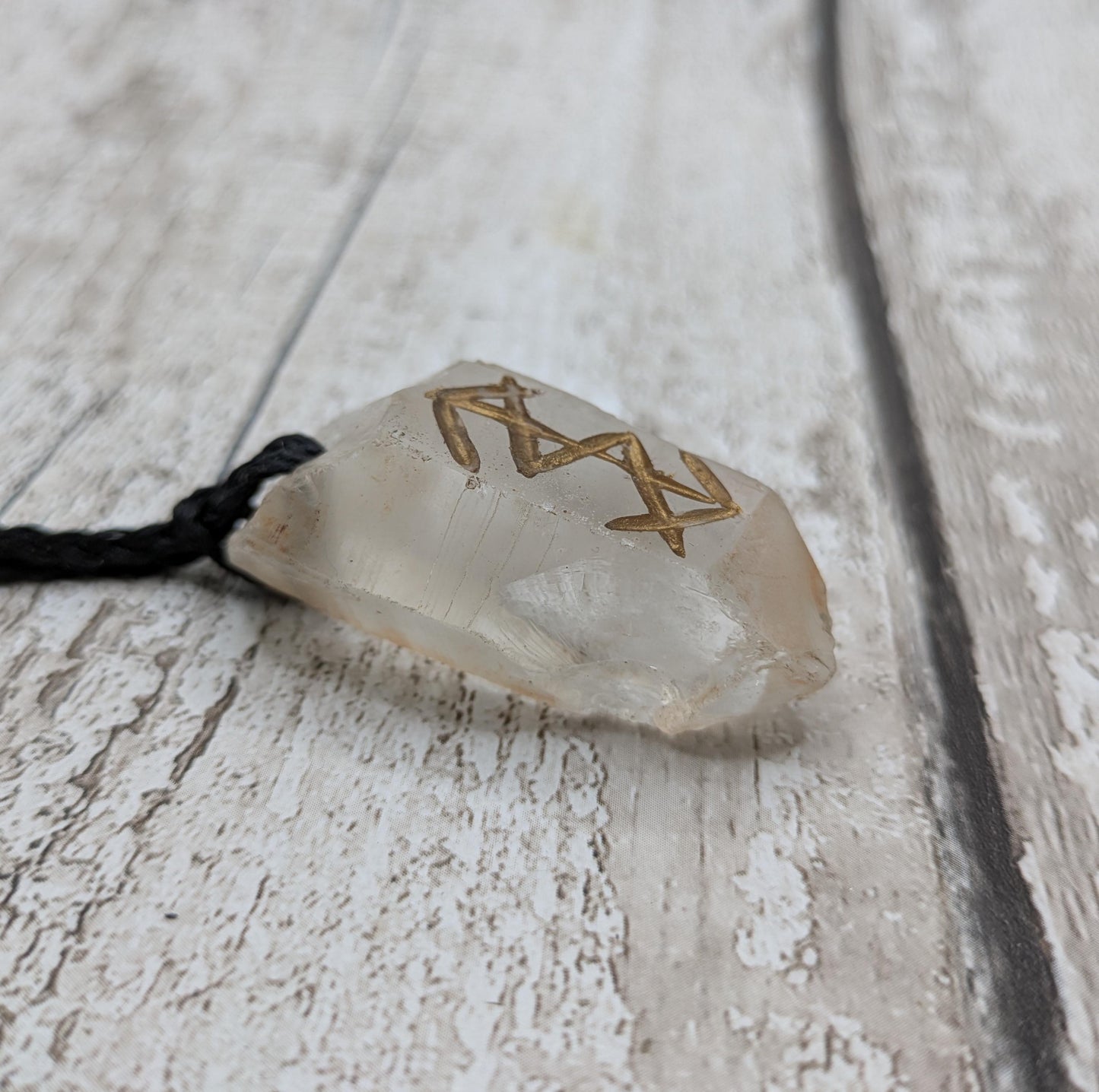 Clear quartz point bind rune empowerment pendant.