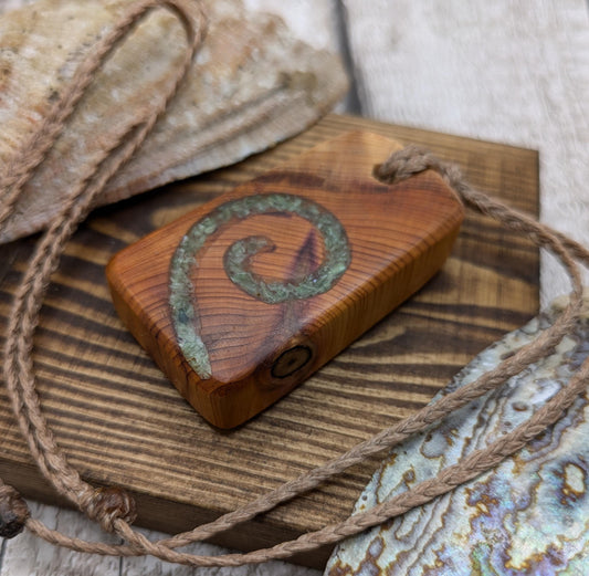 yew wood pendant with Alaskan jade koru inlay.