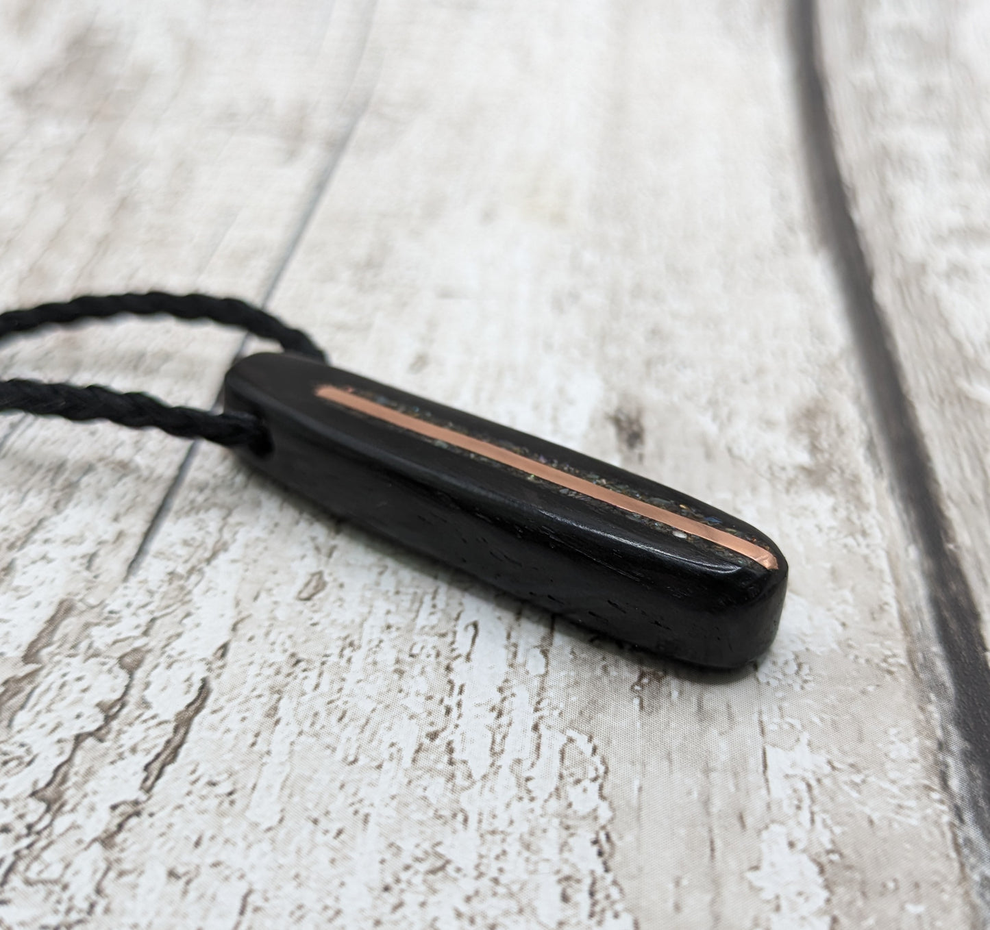 Fenland bog oak oval pendant with NZ pāua shell and copper wire