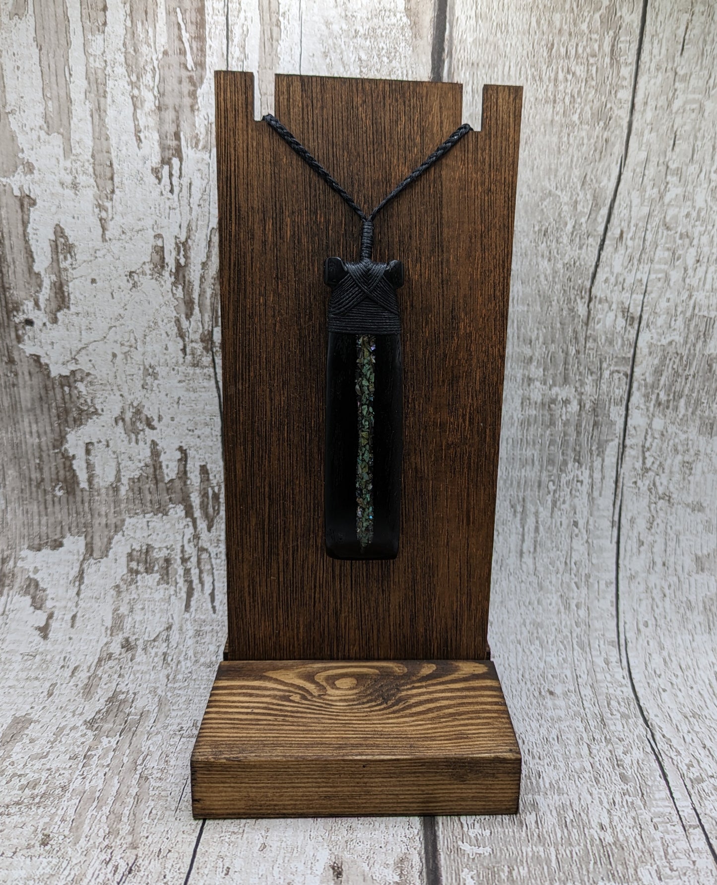 Fenland bog oak hei toki adze with pāua and pounamu.