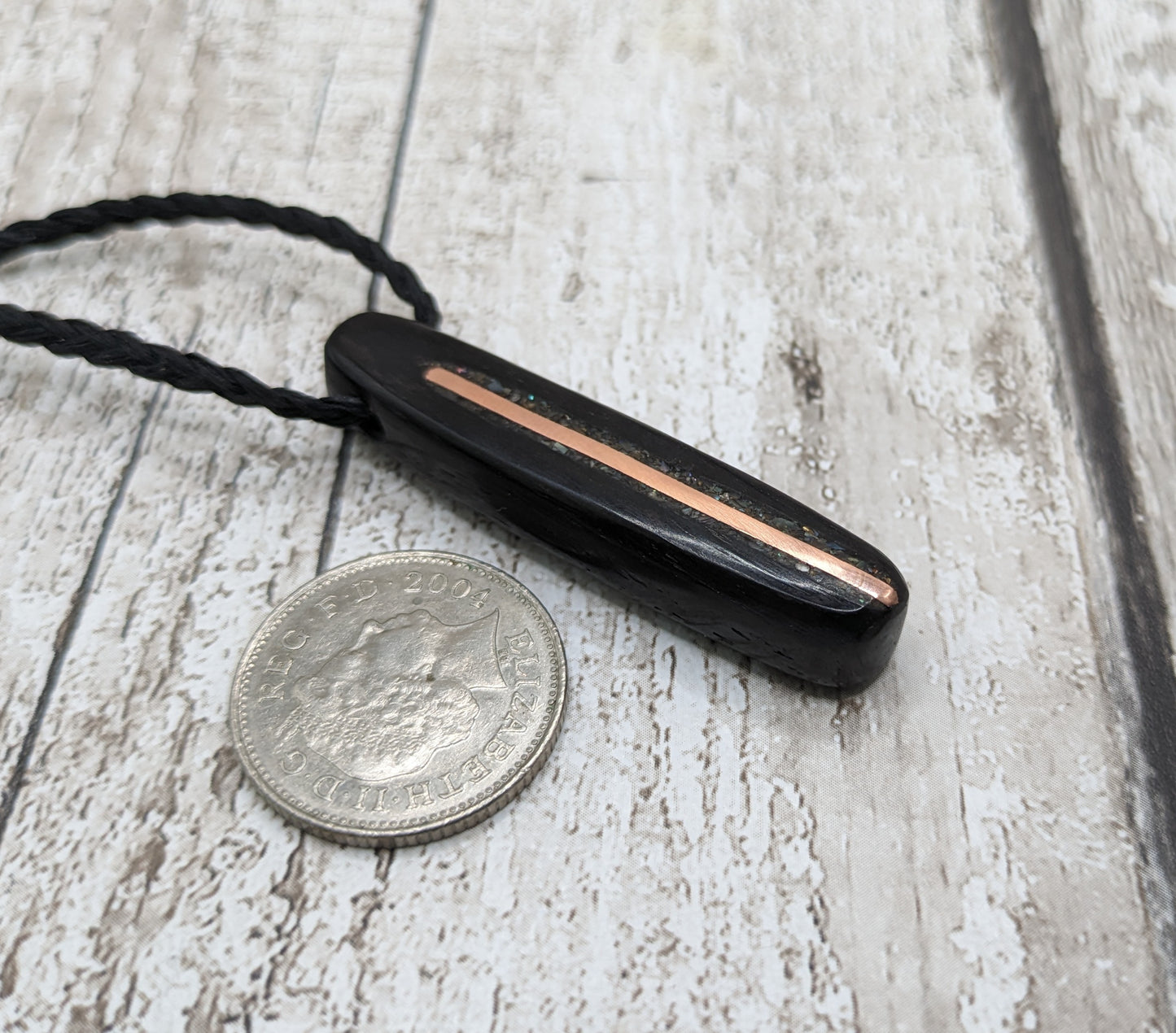 Fenland bog oak oval pendant with NZ pāua shell and copper wire