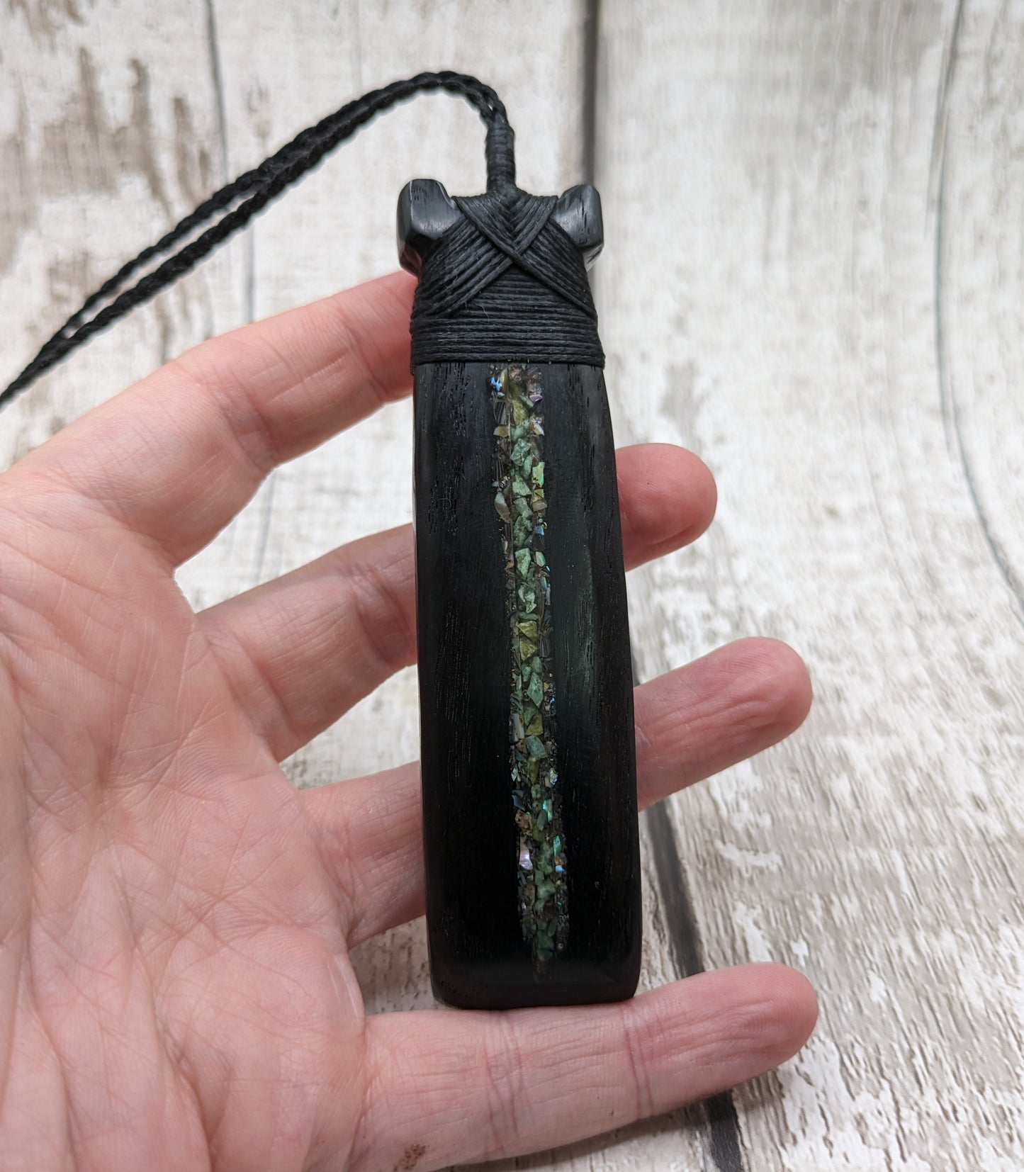 Fenland bog oak hei toki adze with pāua and pounamu.