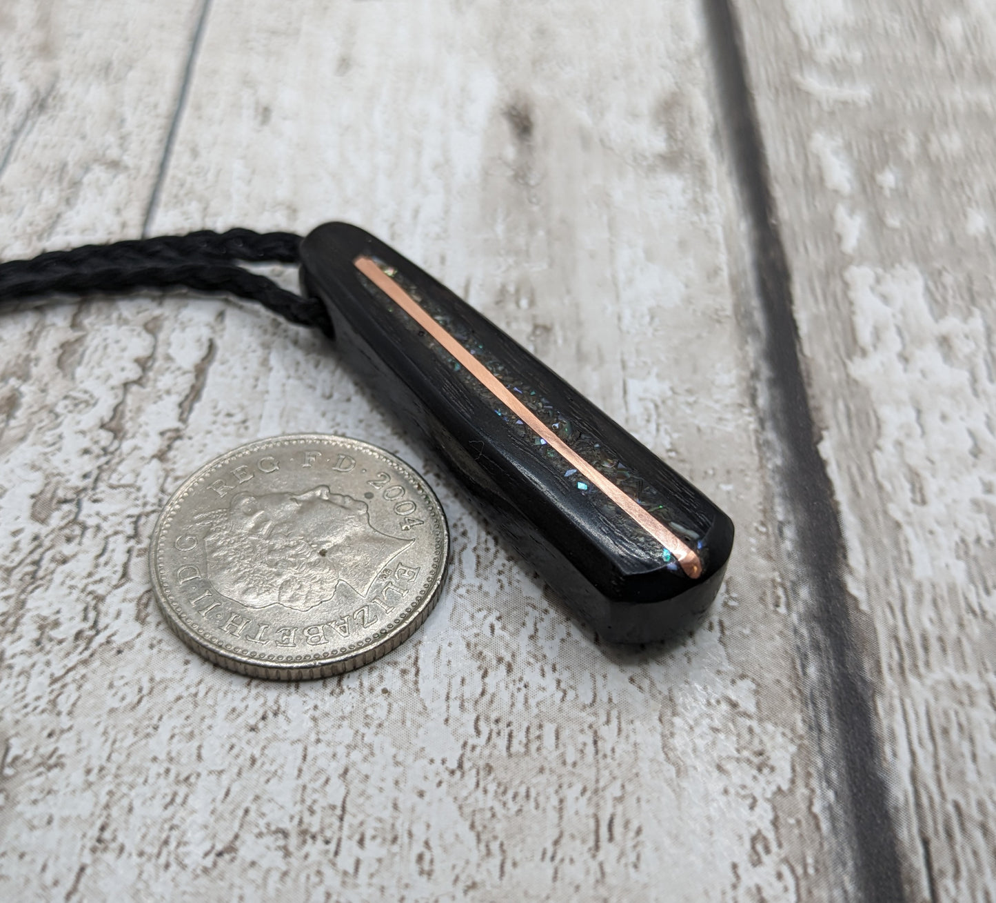 Fenland my bog oak roimata pendant with NZ pāua shell and copper wire.