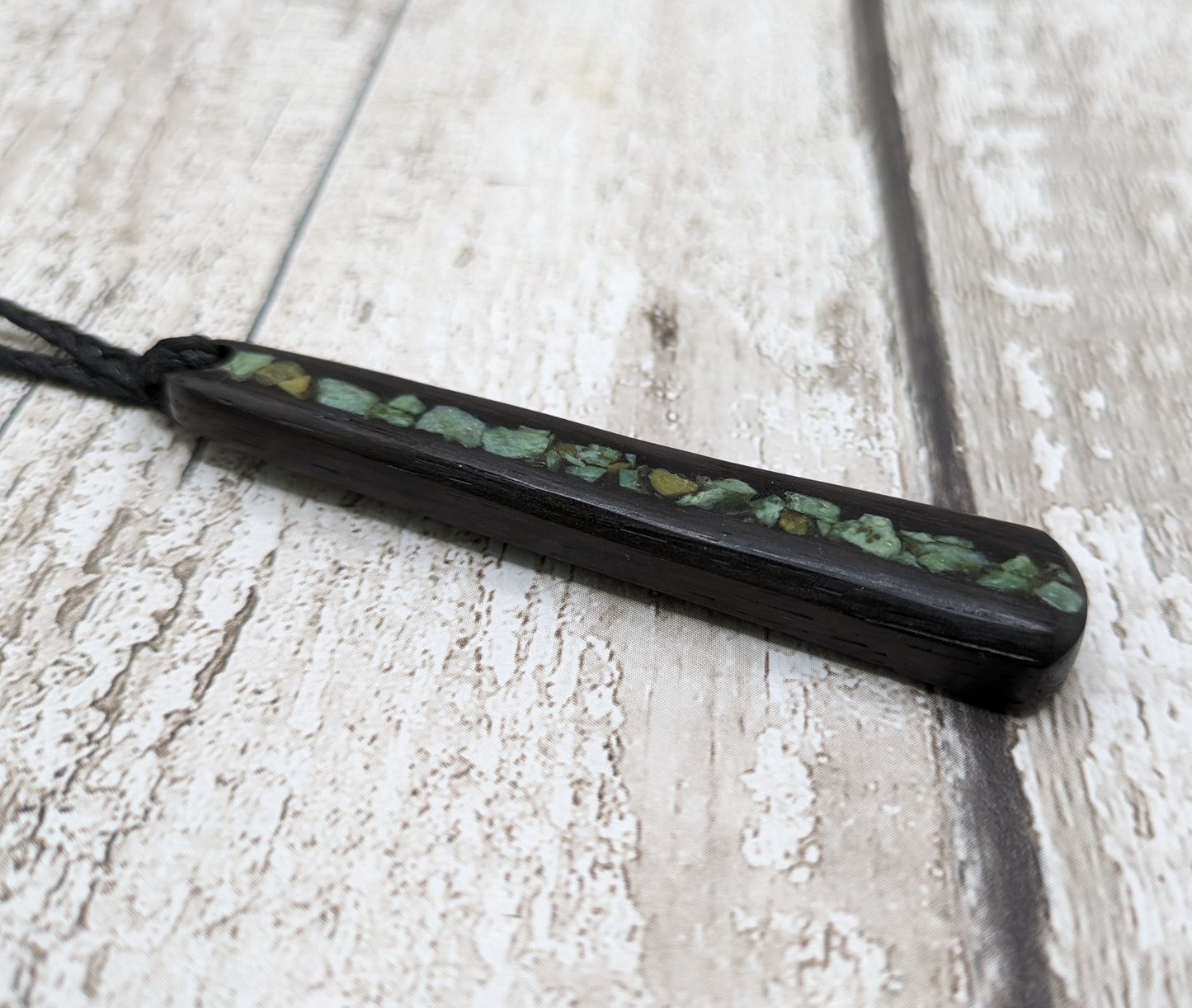 Fenland bog oak roimata with NZ greenstone pounamu pendant.