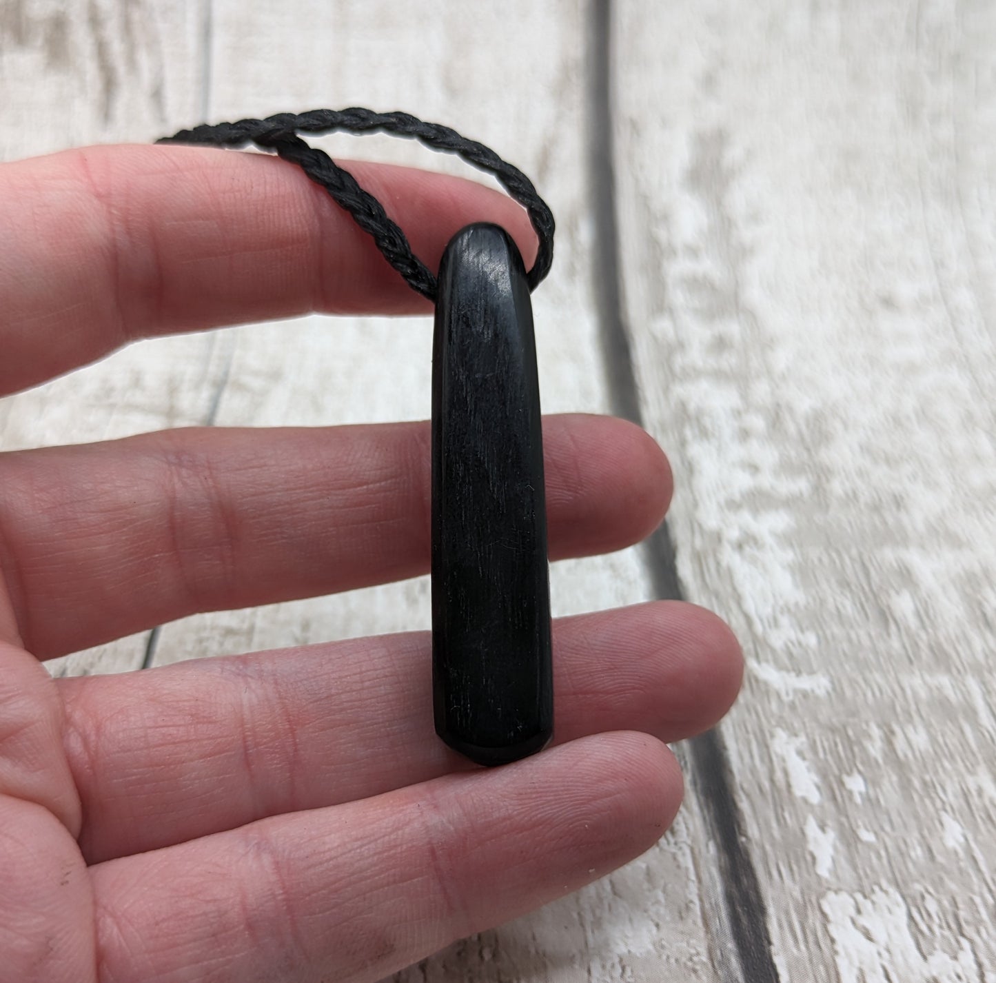 Fenland bog oak roimata pendant with copper wire and abalone shell.