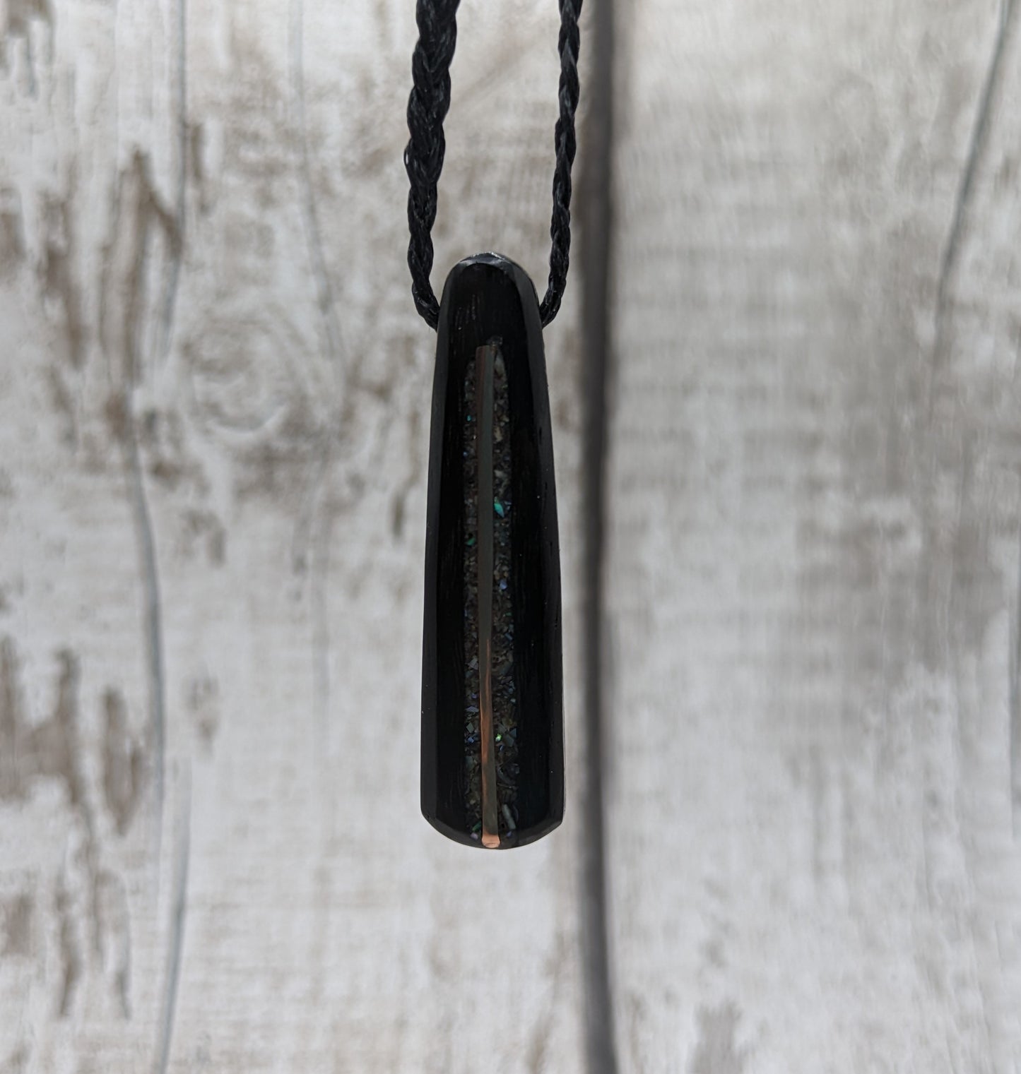 Fenland my bog oak roimata pendant with NZ pāua shell and copper wire.