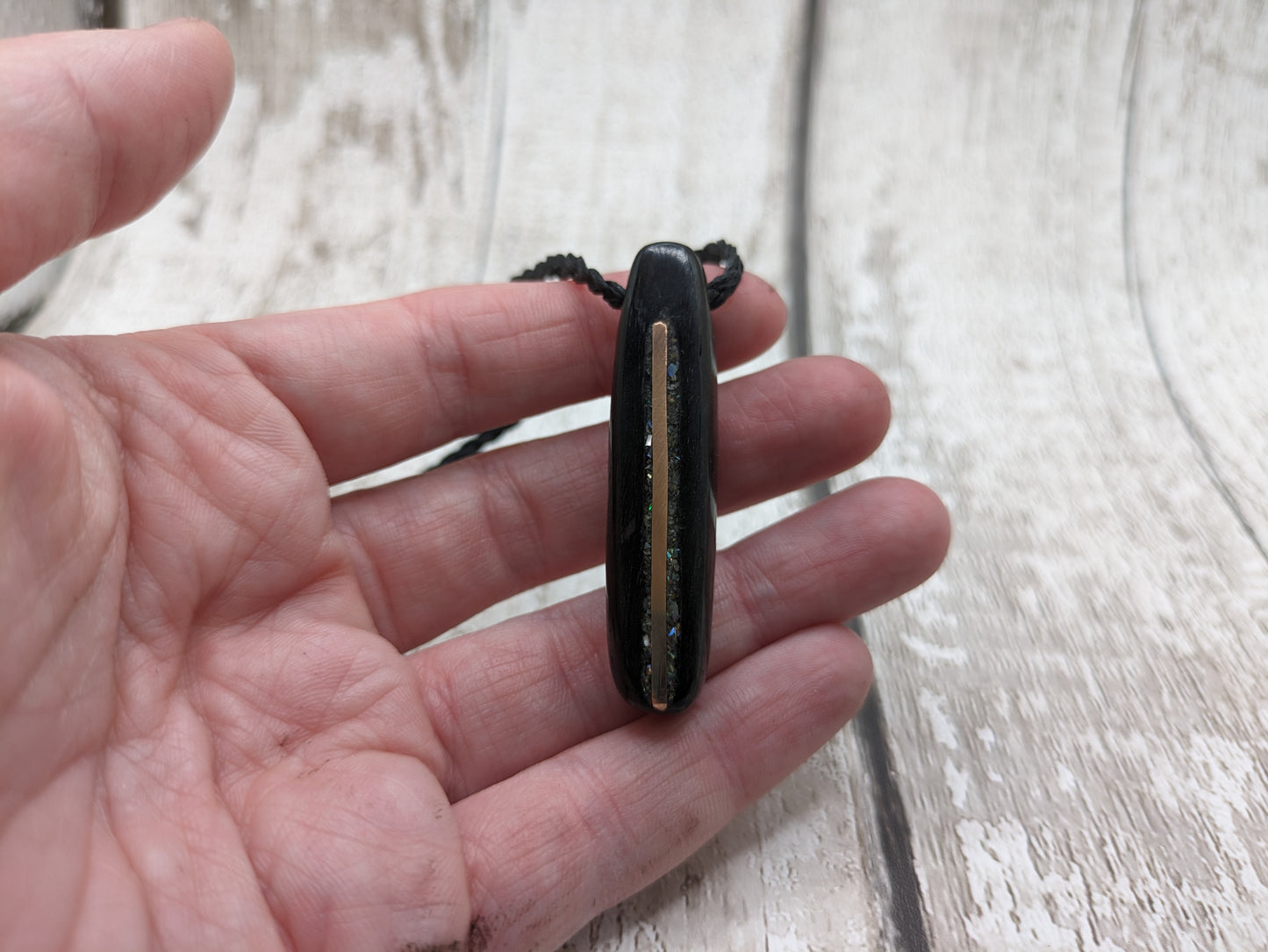 Fenland bog oak oval pendant with NZ pāua shell and copper wire