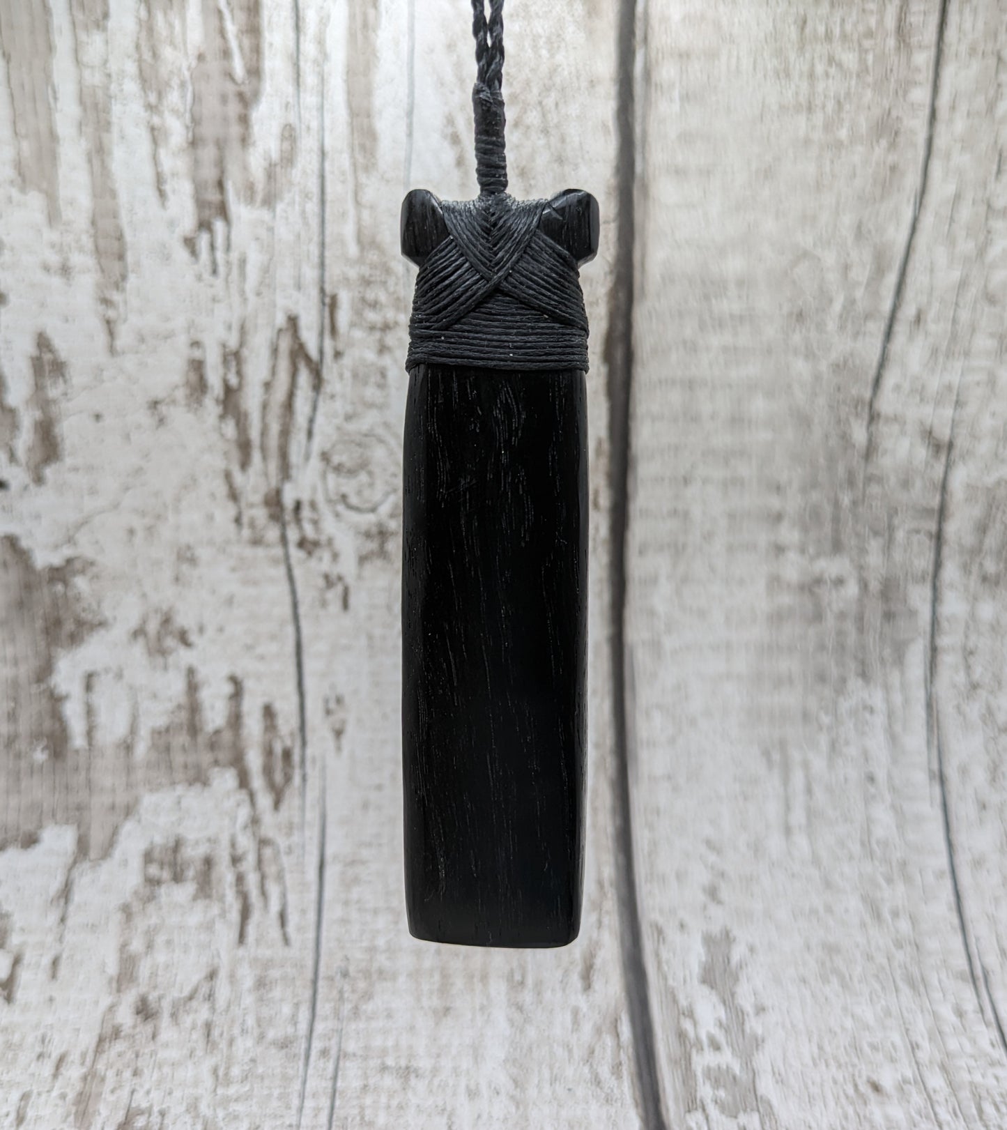 Fenland bog oak hei toki adze with pāua and pounamu.