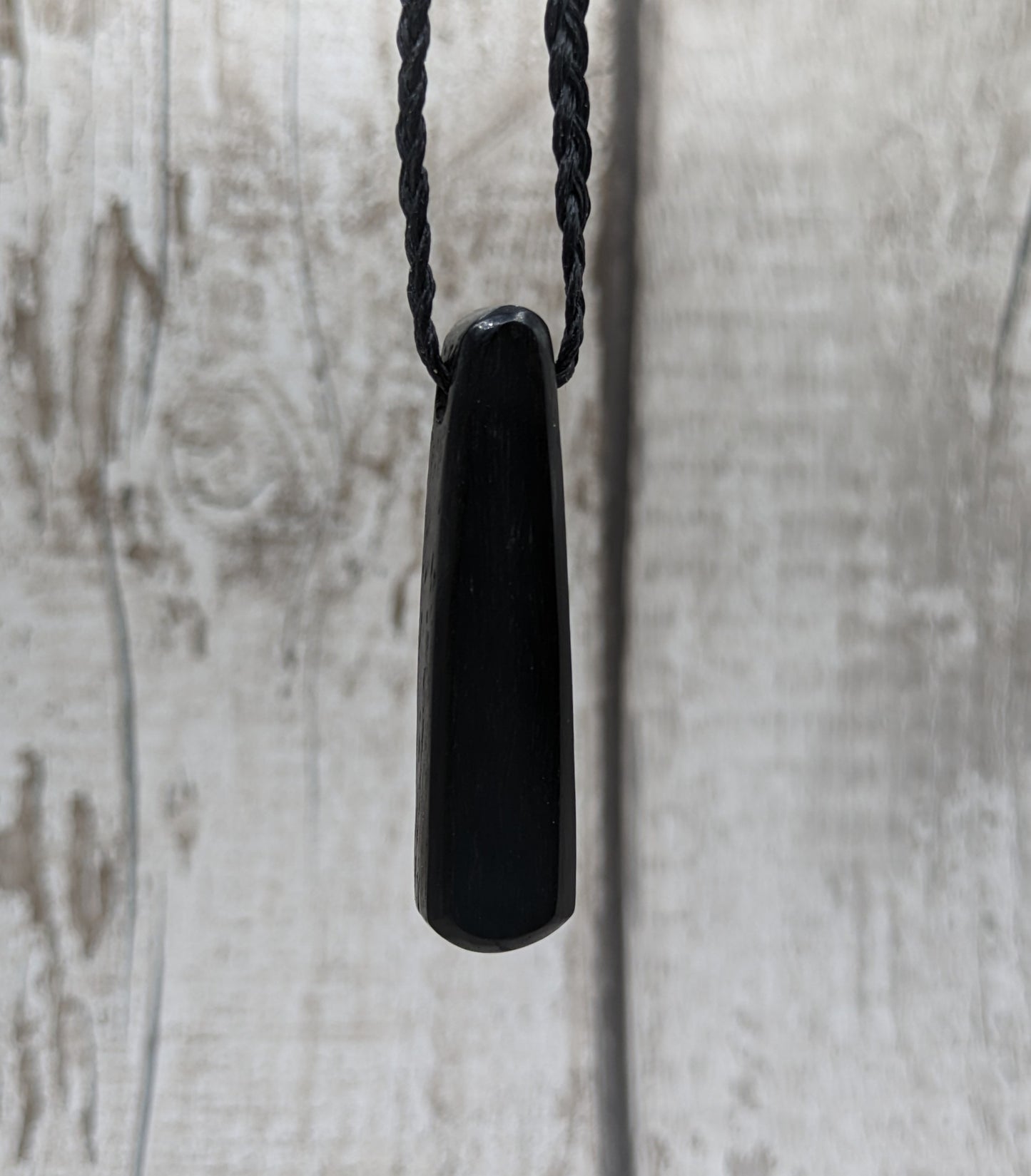 Fenland my bog oak roimata pendant with NZ pāua shell and copper wire.