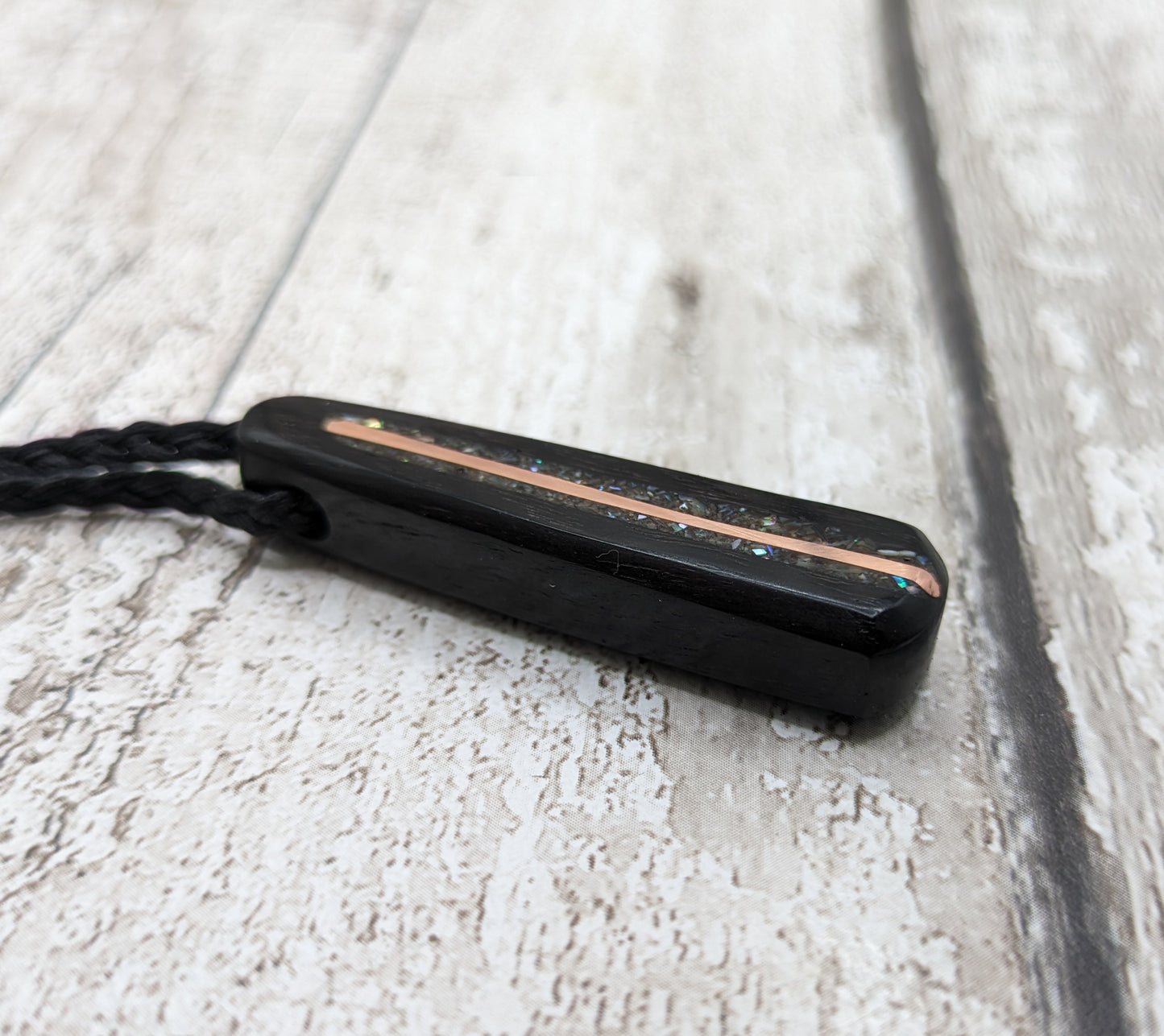 Fenland my bog oak roimata pendant with NZ pāua shell and copper wire.