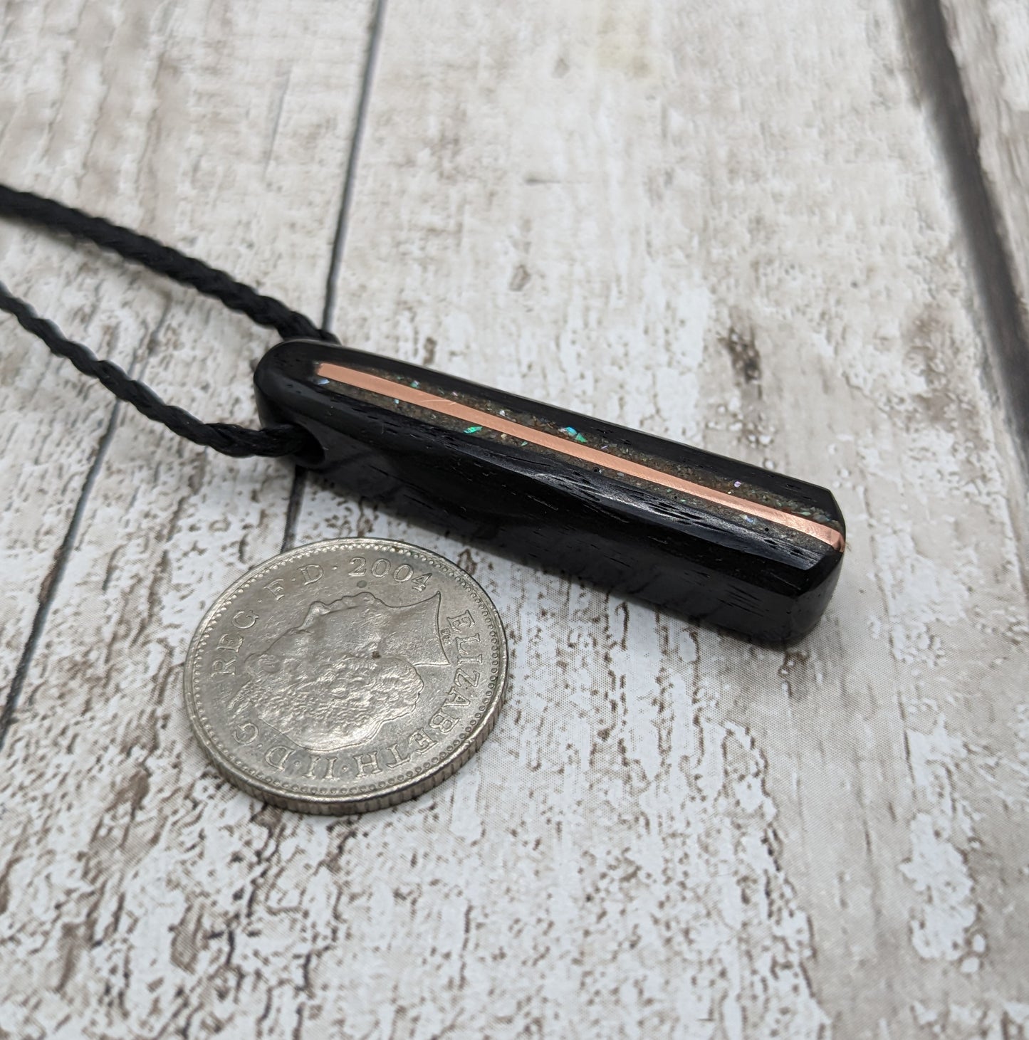 Fenland bog oak roimata pendant with copper wire and abalone shell.