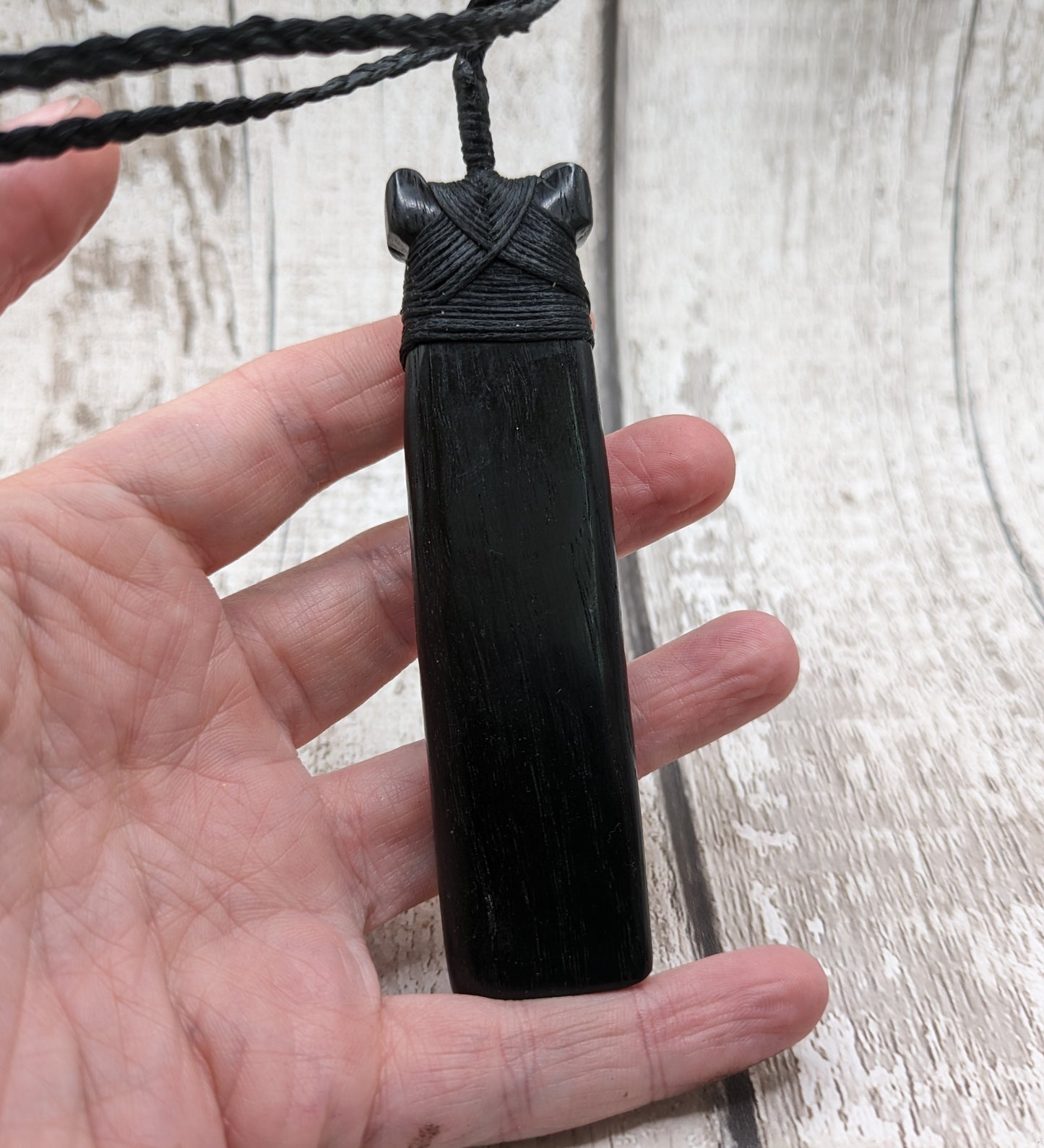 Fenland bog oak hei toki adze with pāua and pounamu.