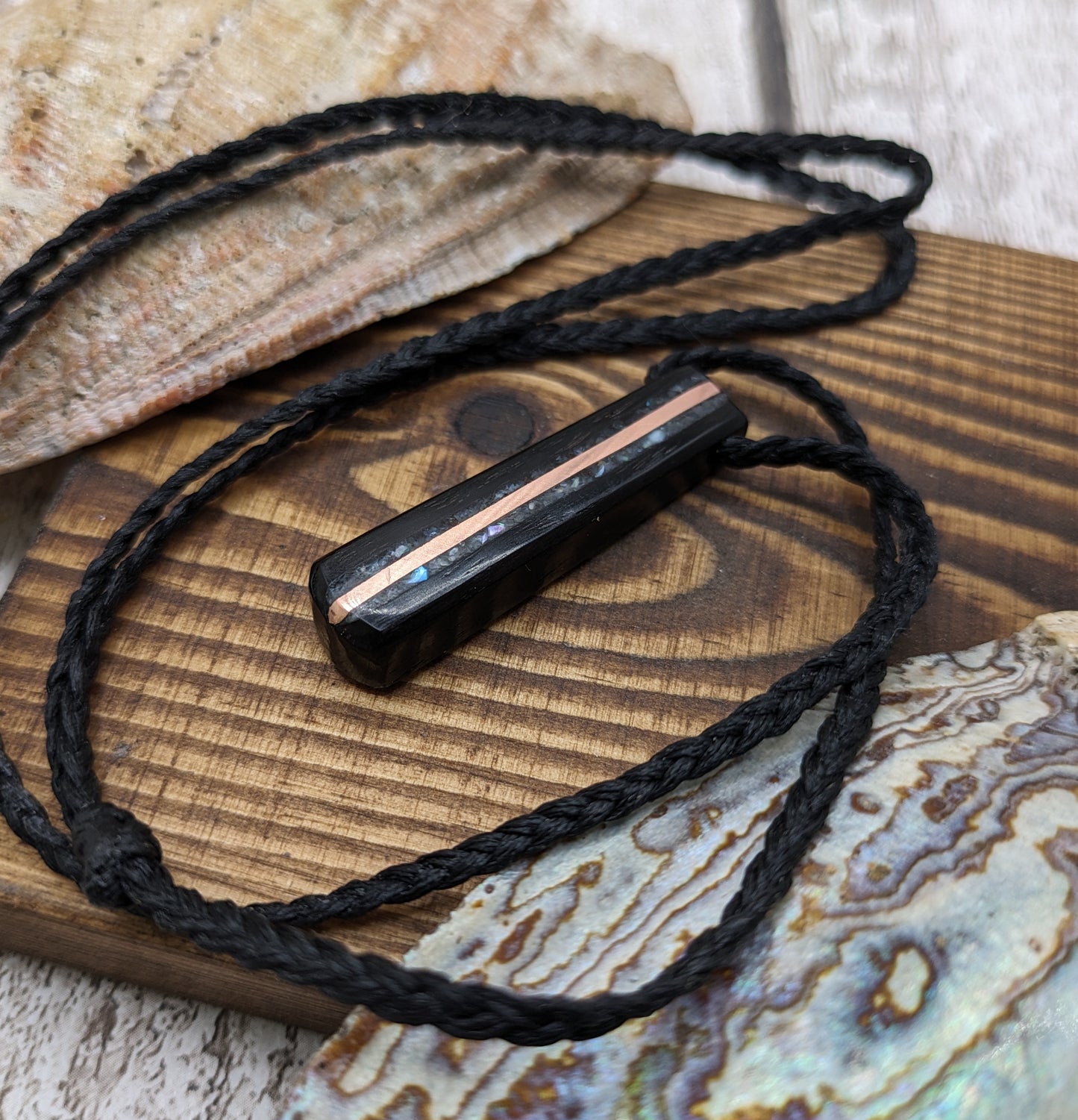 Fenland bog oak roimata pendant with mussel shell and copper wire