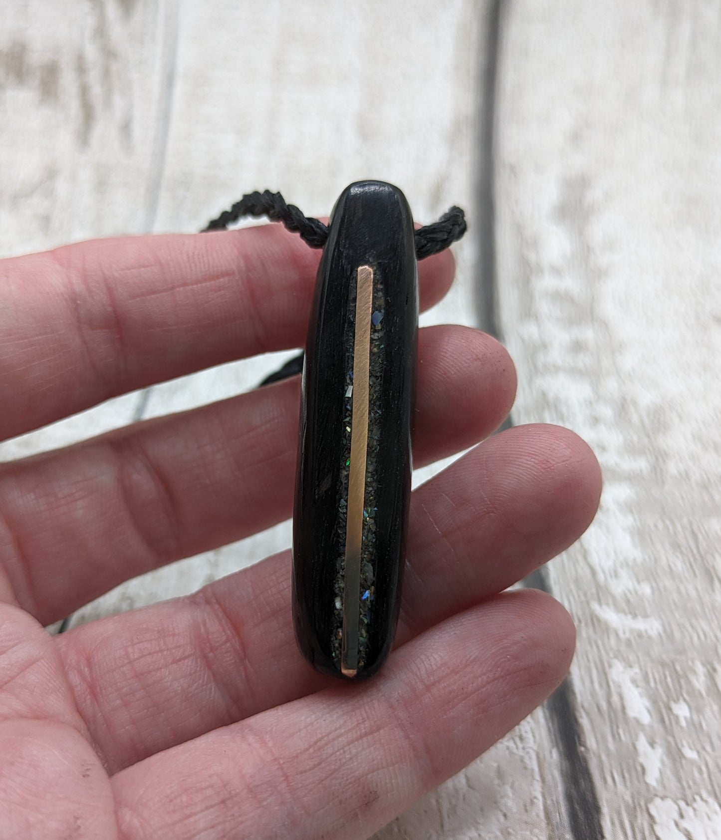 Fenland bog oak oval pendant with NZ pāua shell and copper wire