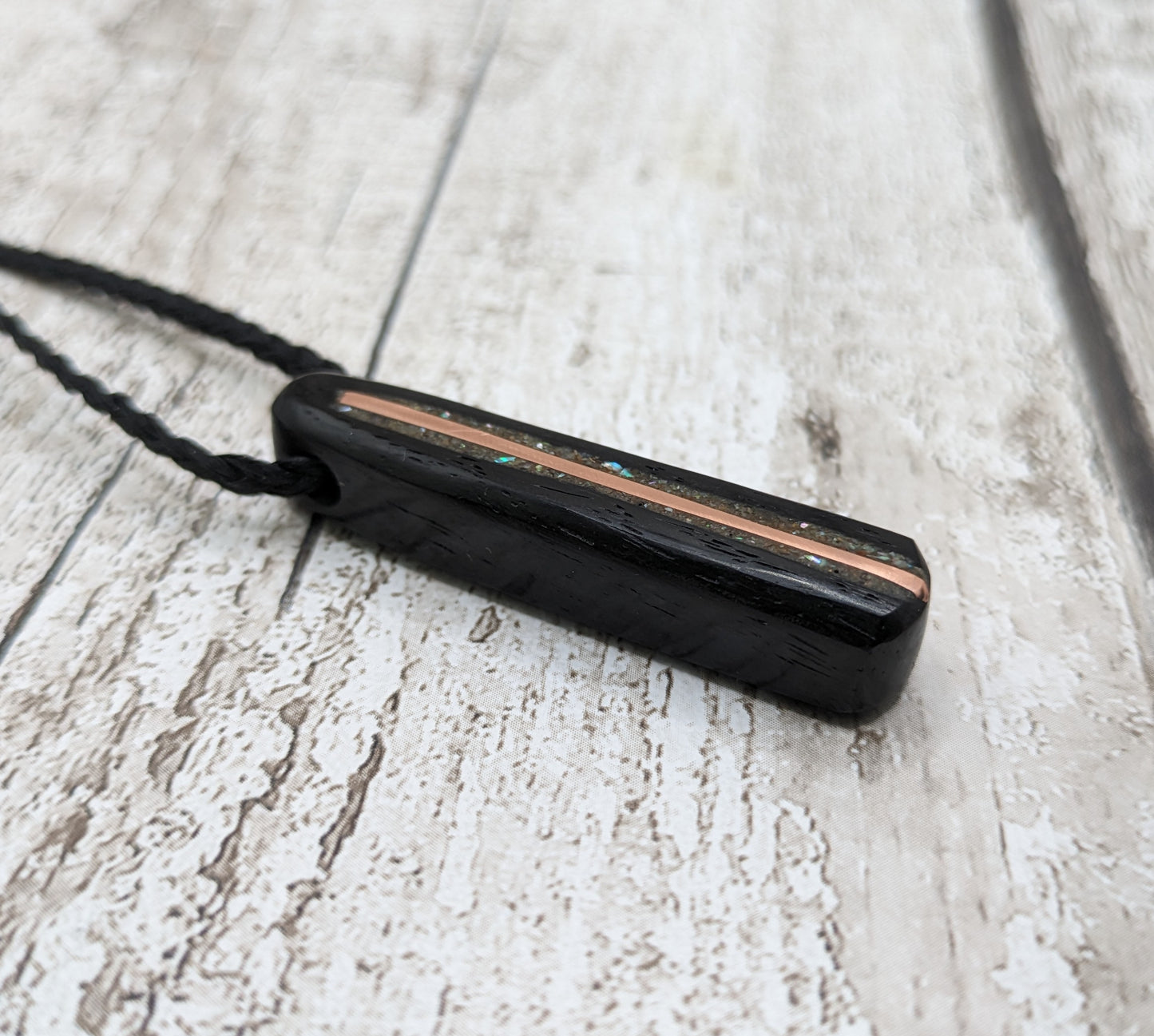 Fenland bog oak roimata pendant with copper wire and abalone shell.