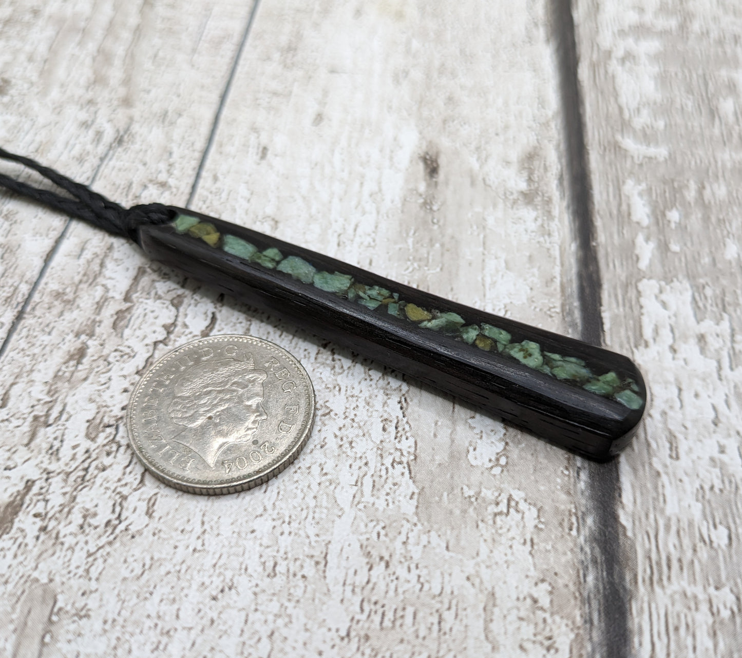 Fenland bog oak roimata with NZ greenstone pounamu pendant.