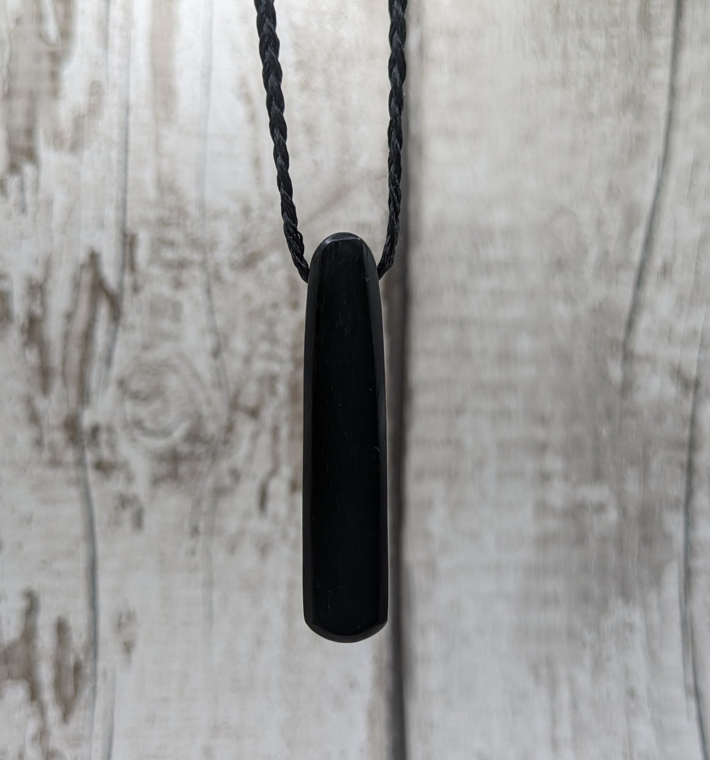 Fenland bog oak oval pendant with NZ pāua shell and copper wire