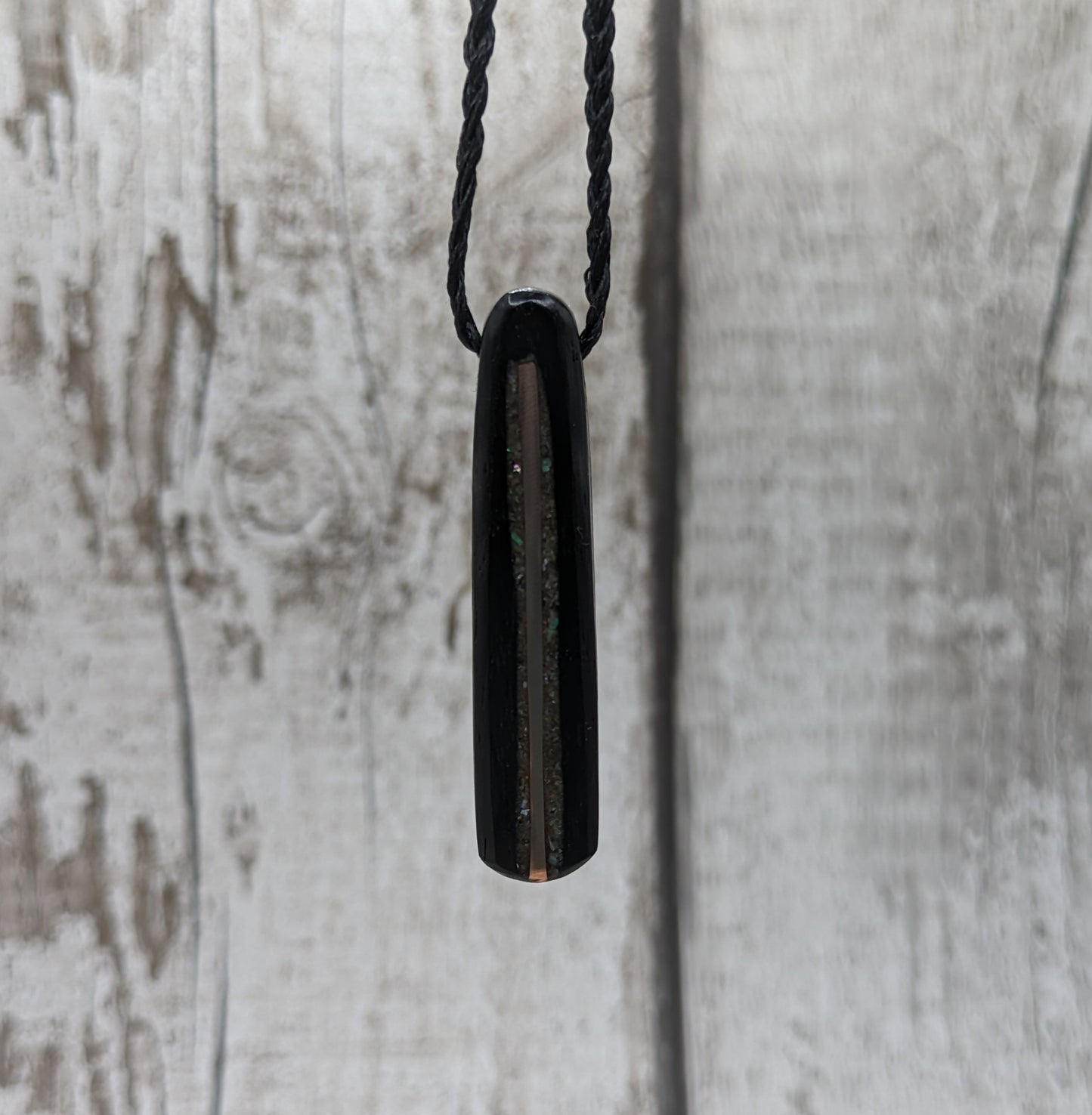 Fenland bog oak roimata pendant with copper wire and abalone shell.