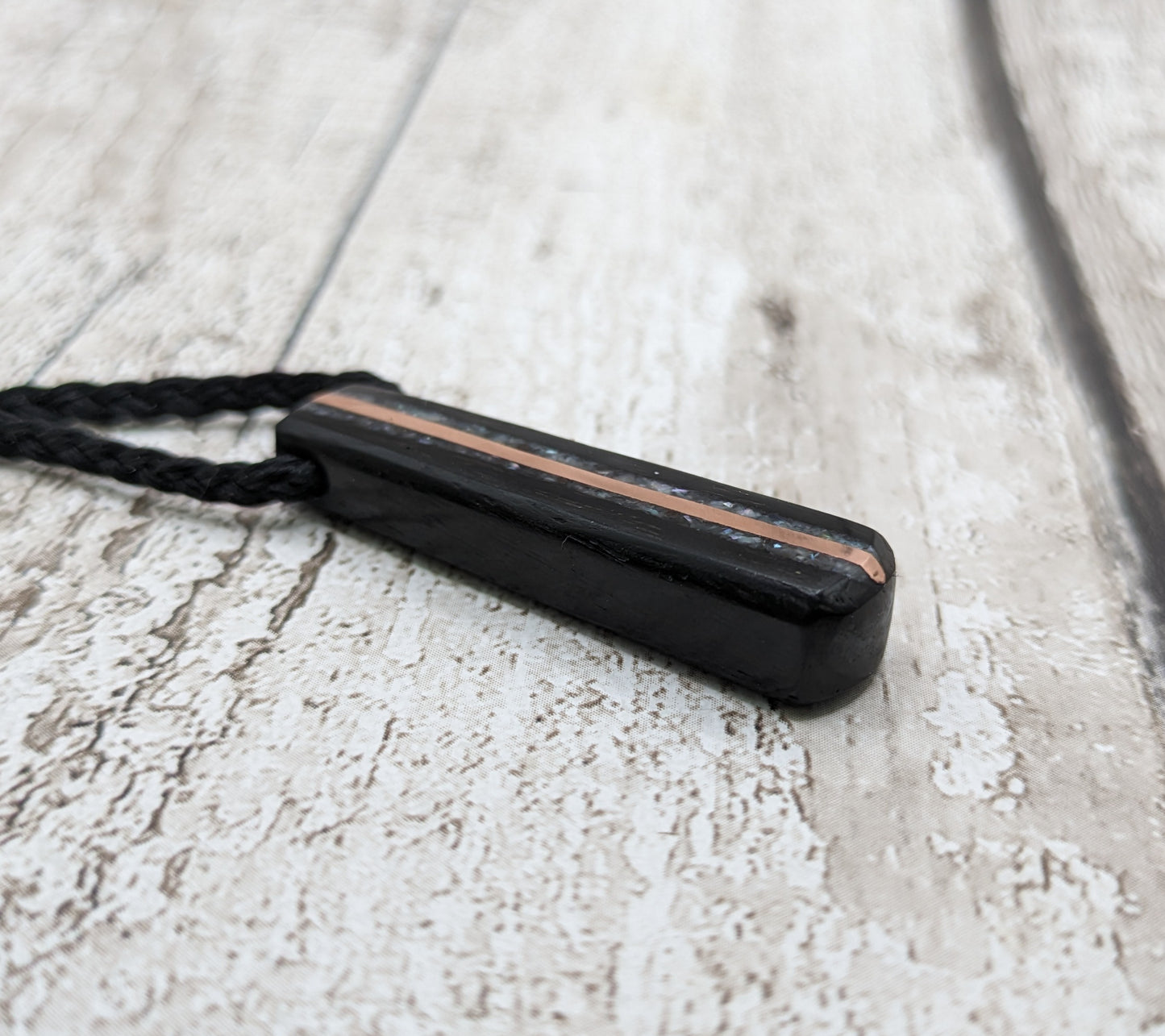 Fenland bog oak roimata pendant with mussel shell and copper wire