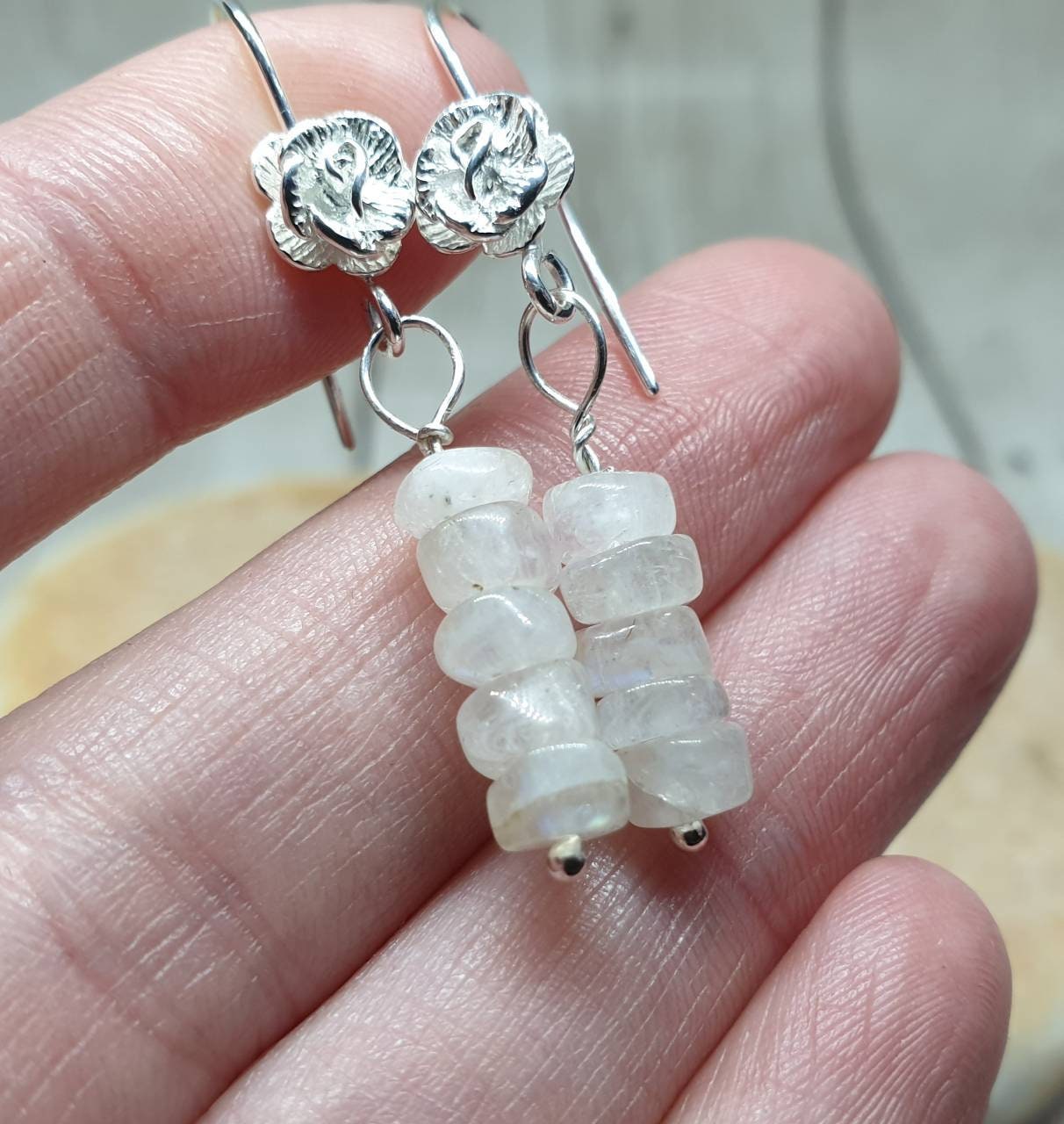 Spectrolite moonstone on 925 sterling silver fish hook earrings with rose detail.