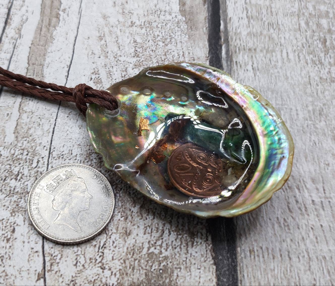 New Zealand pounamu greenstone serpentine roimata in epoxy resin and paua shell pendant.