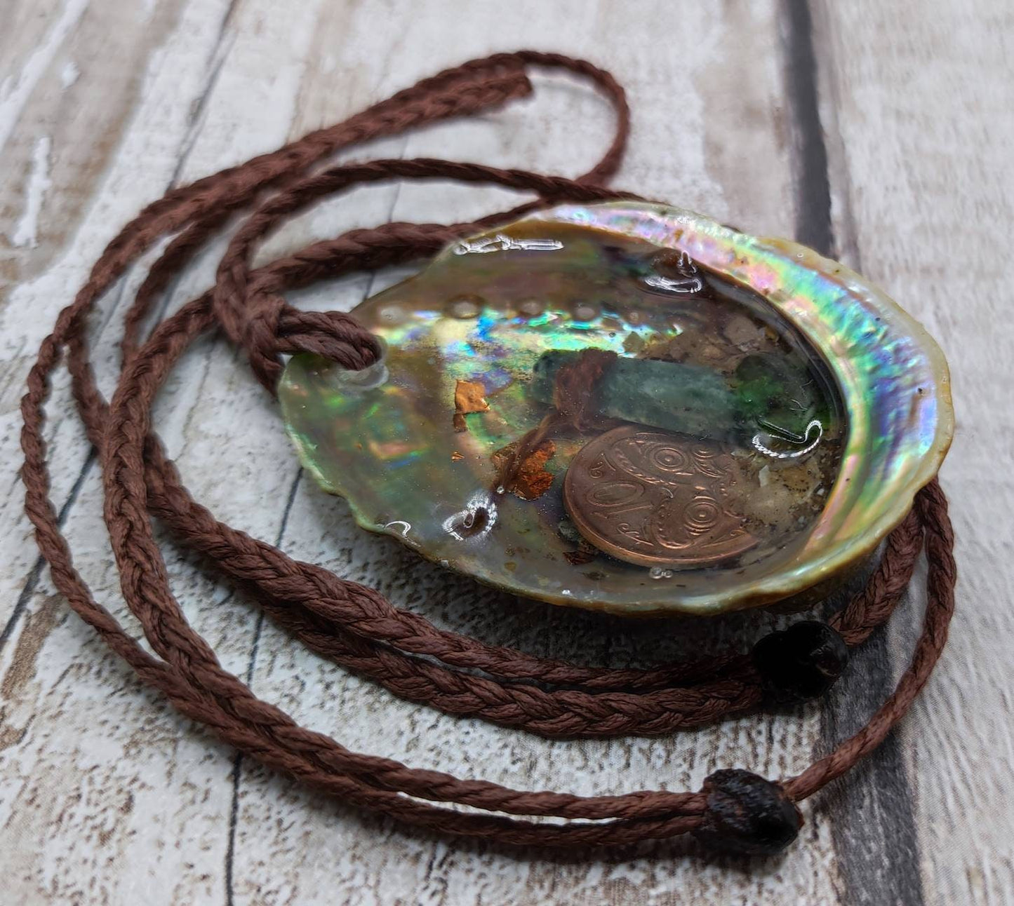 New Zealand pounamu greenstone serpentine roimata in epoxy resin and paua shell pendant.