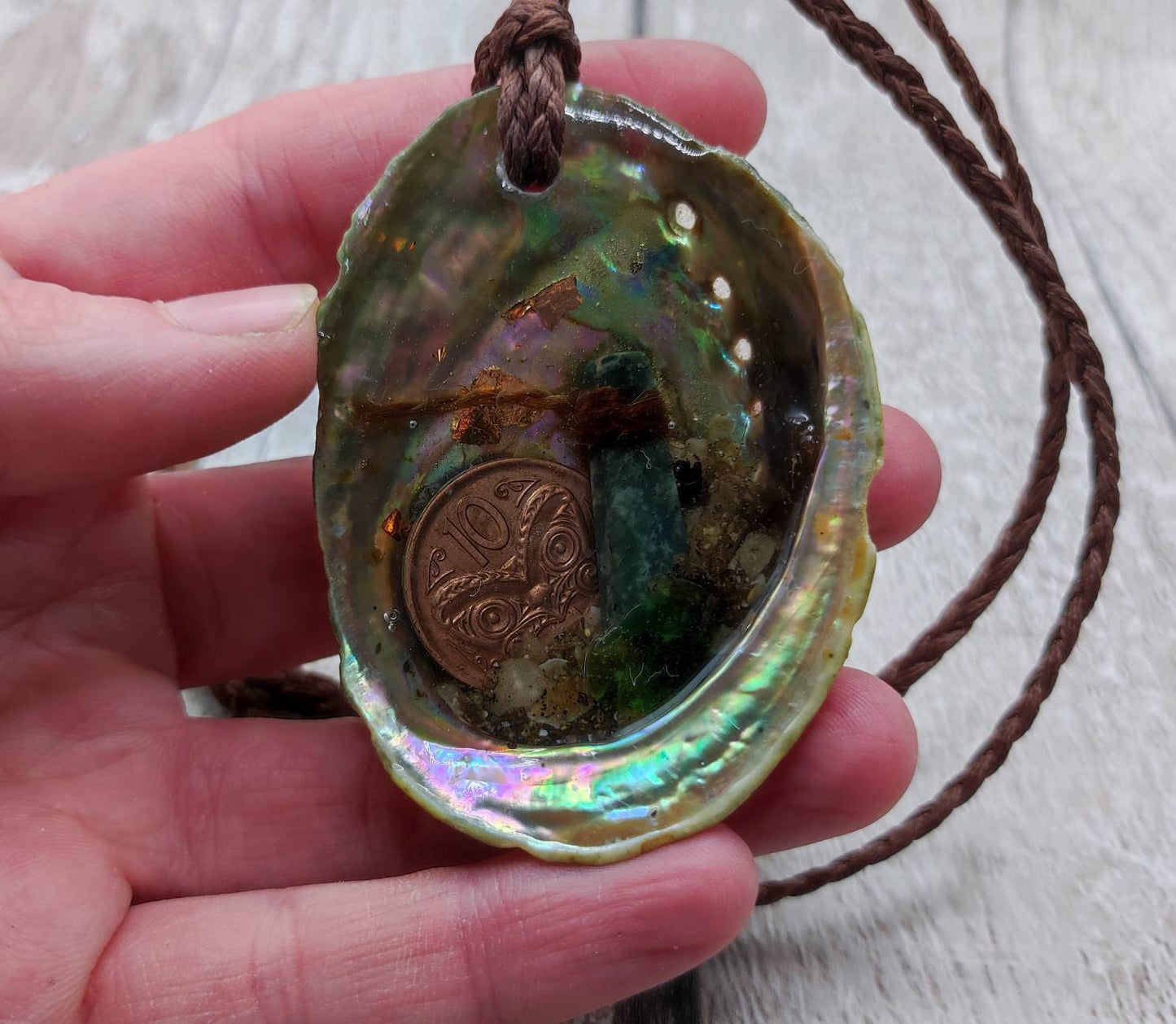 New Zealand pounamu greenstone serpentine roimata in epoxy resin and paua shell pendant.