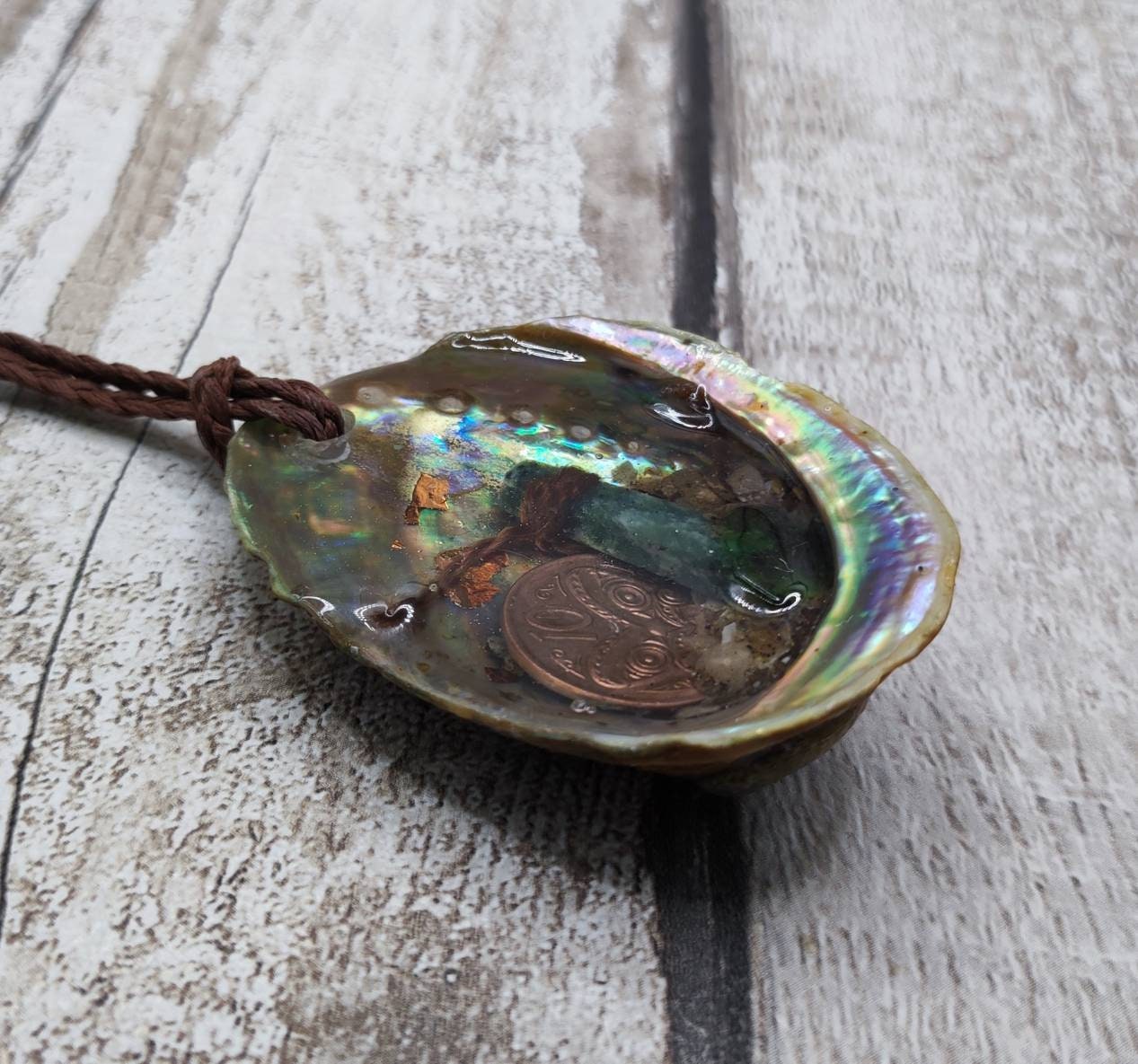 New Zealand pounamu greenstone serpentine roimata in epoxy resin and paua shell pendant.