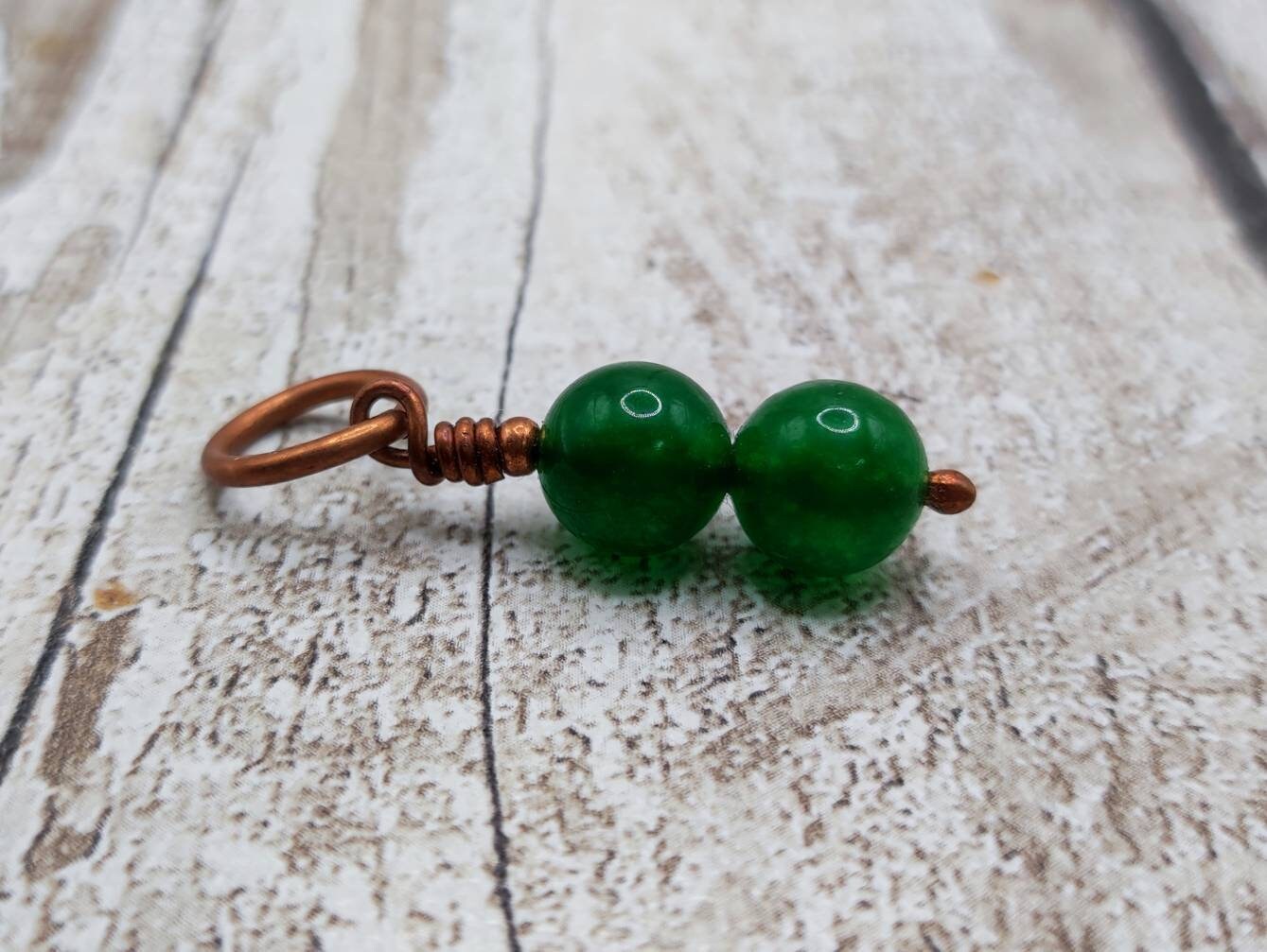 Nephrite jade and copper bracelet charm.