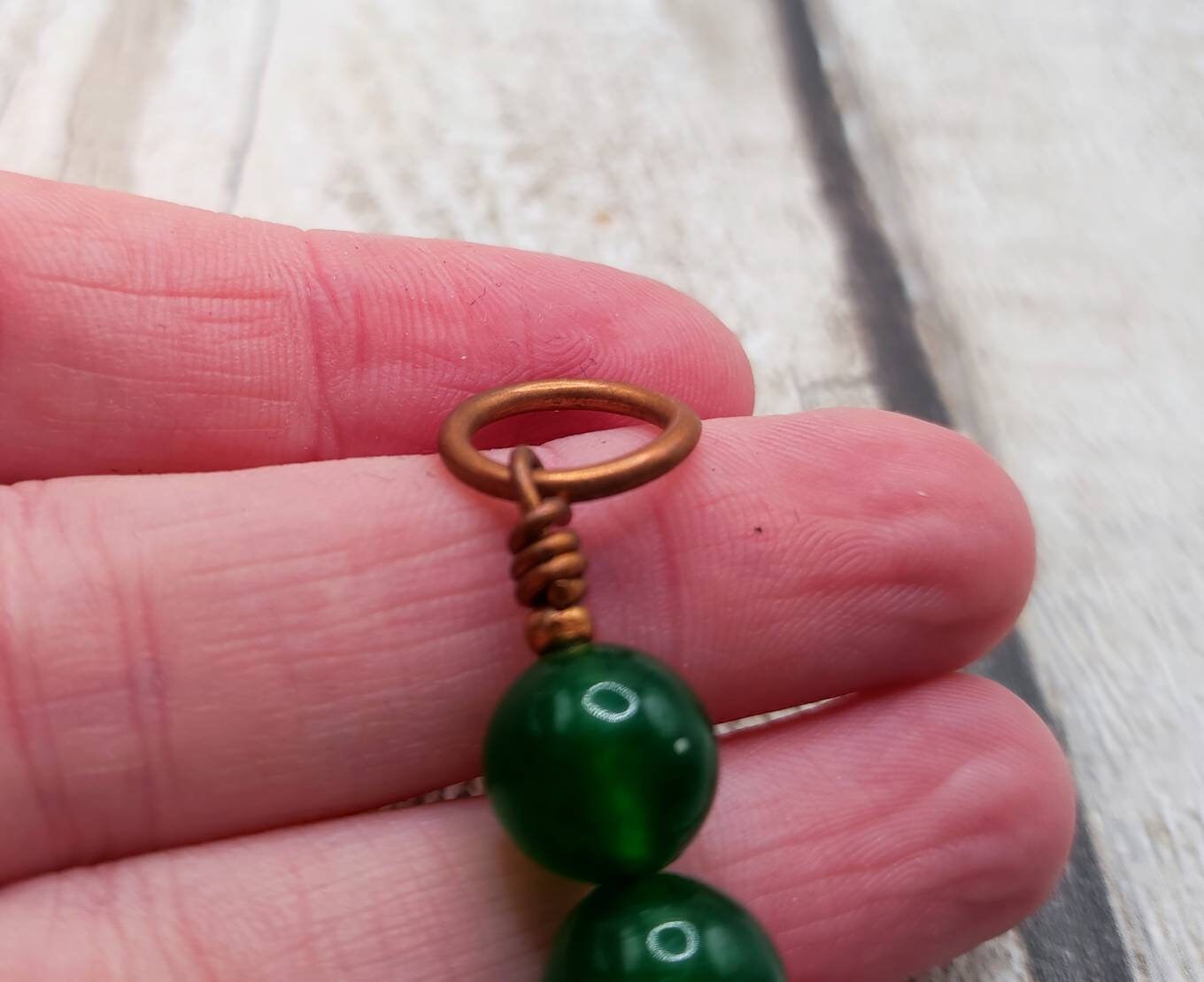 Nephrite jade and copper bracelet charm.