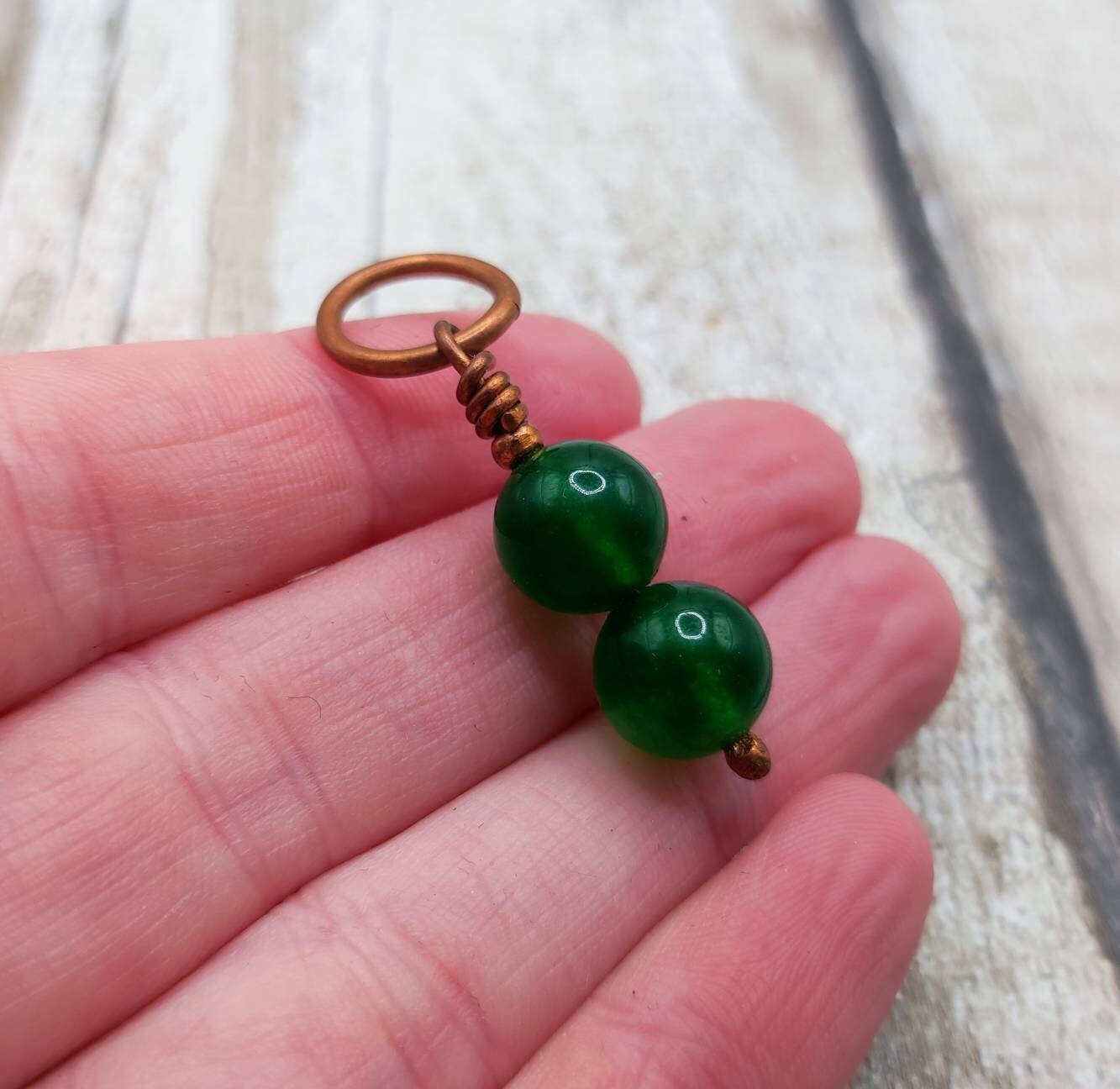 Nephrite jade and copper bracelet charm.