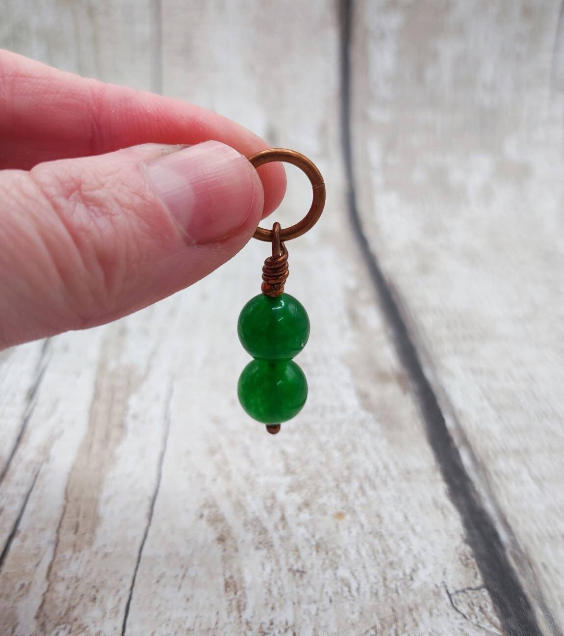 Nephrite jade and copper bracelet charm.