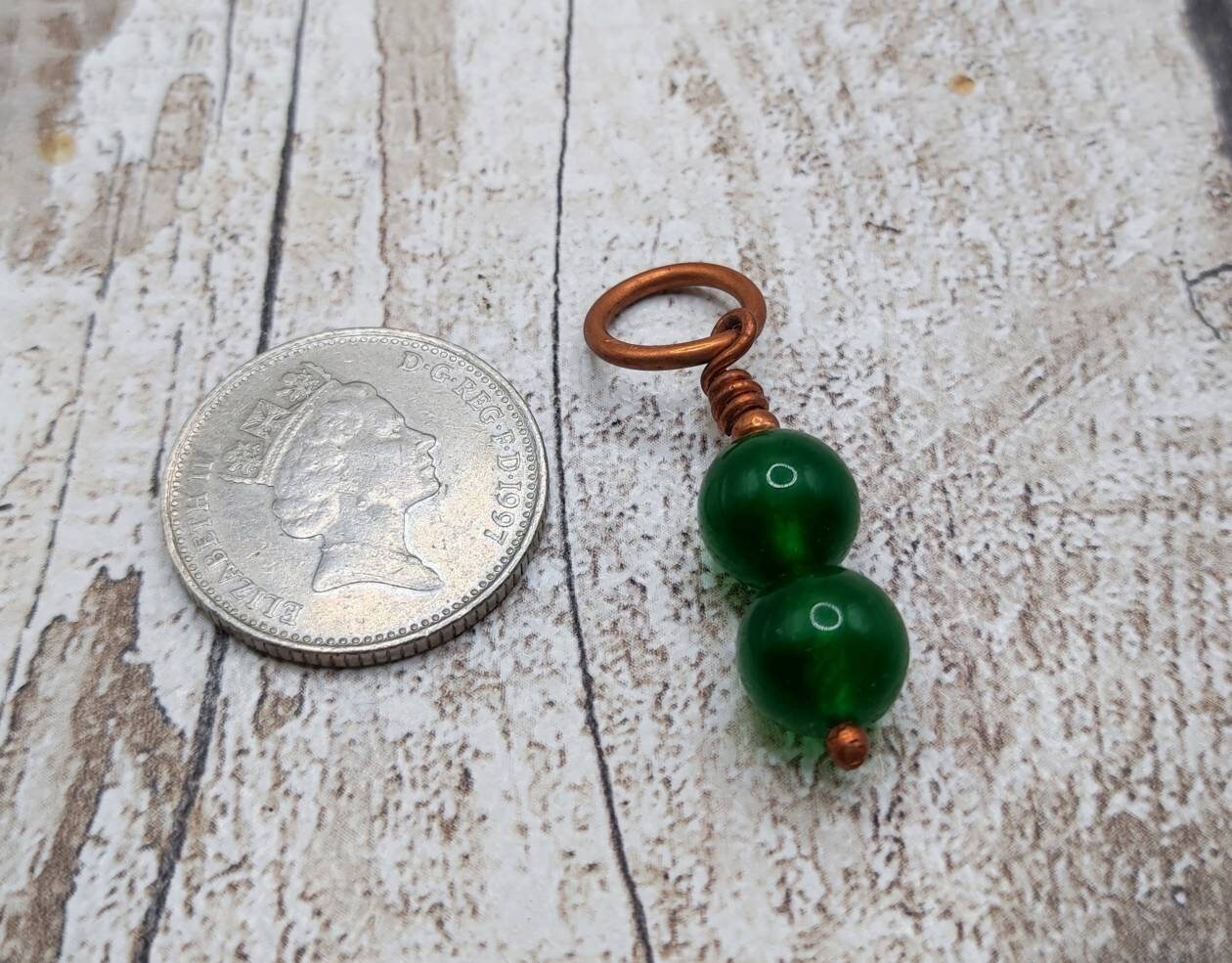 Nephrite jade and copper bracelet charm.