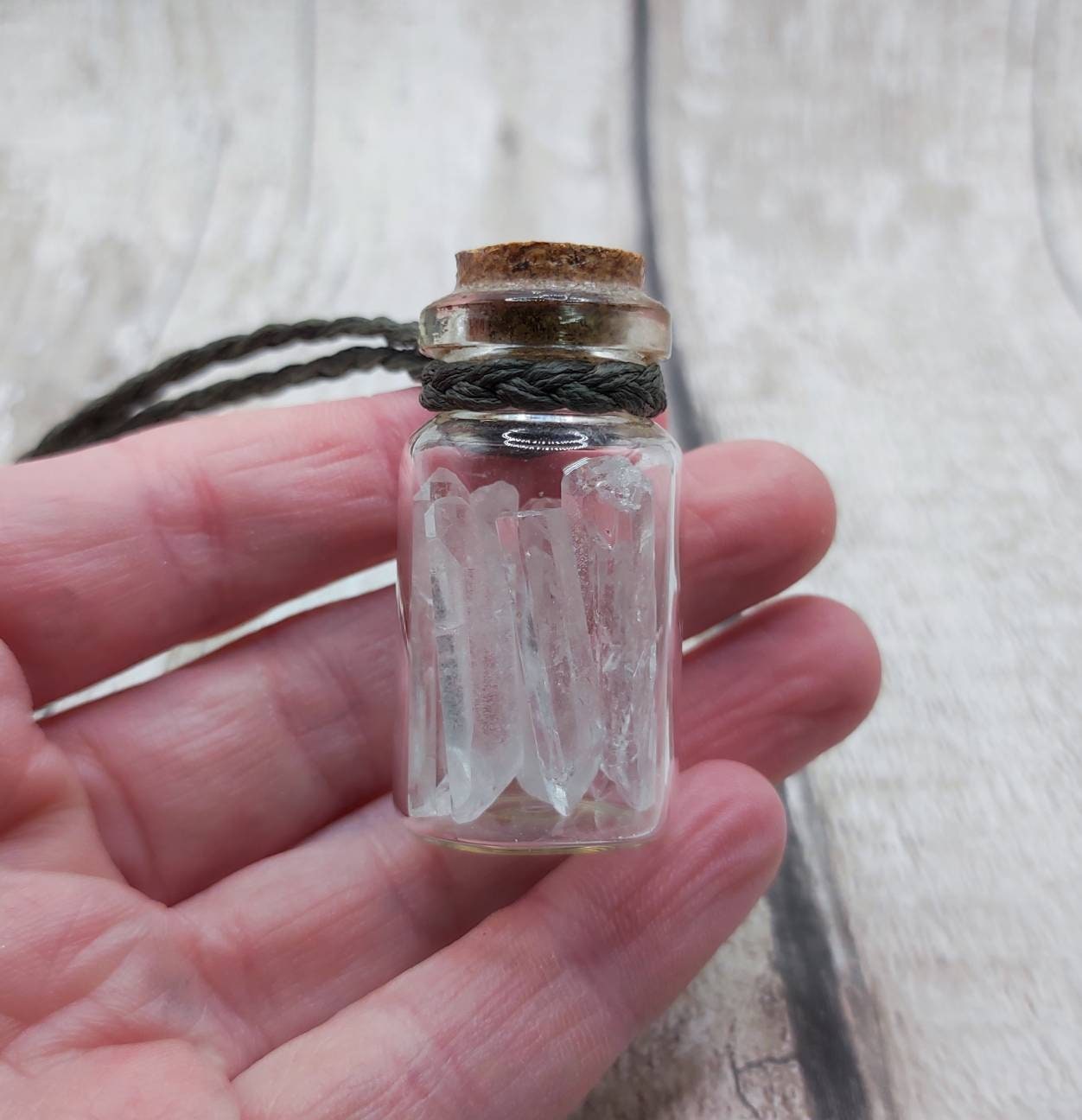 Quartz filled glass bottle pendant.