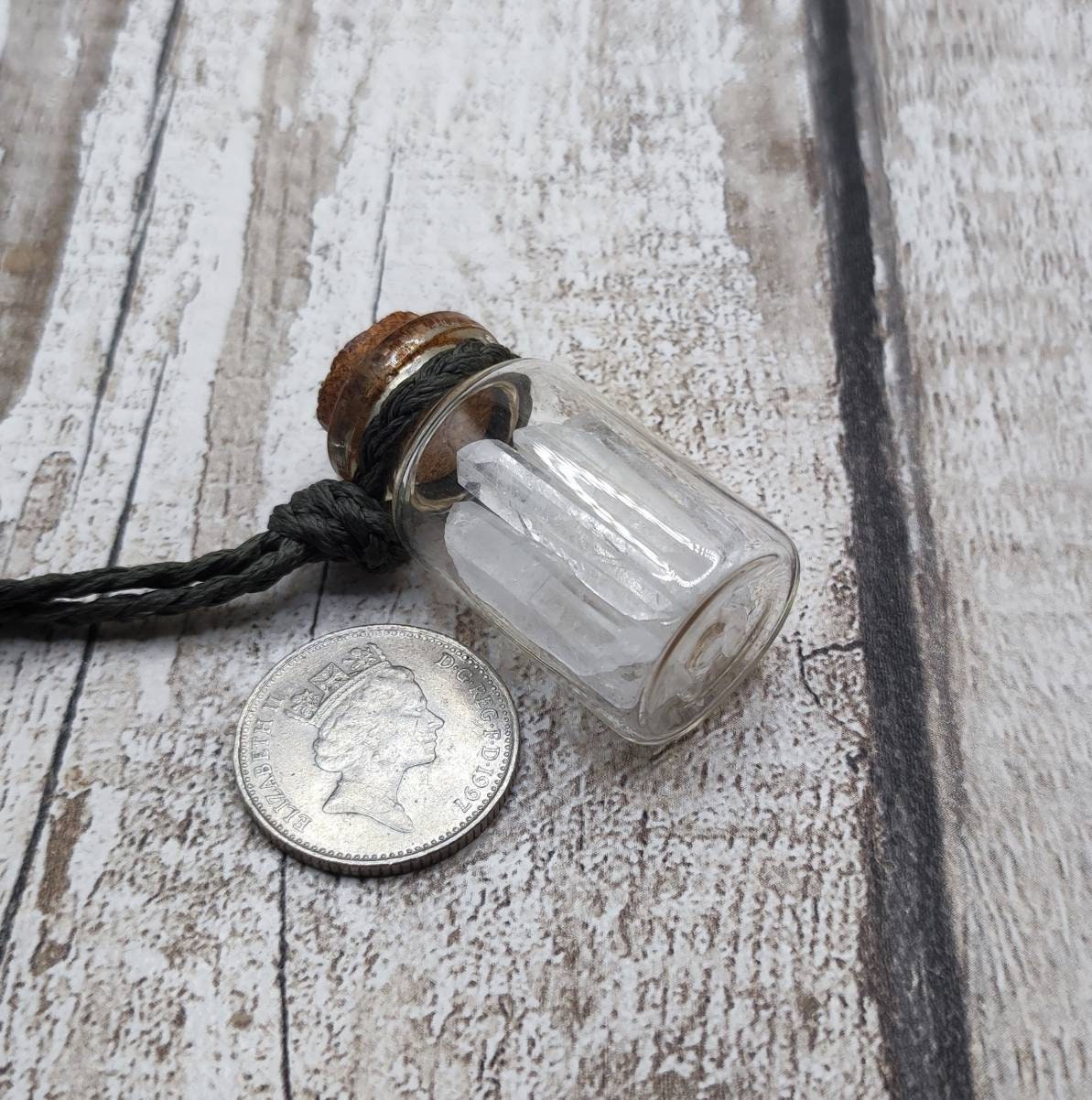 Quartz filled glass bottle pendant.