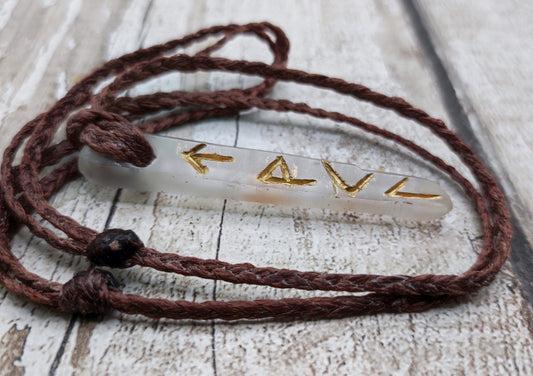 Quartz crystal point rune stone talisman pendant.