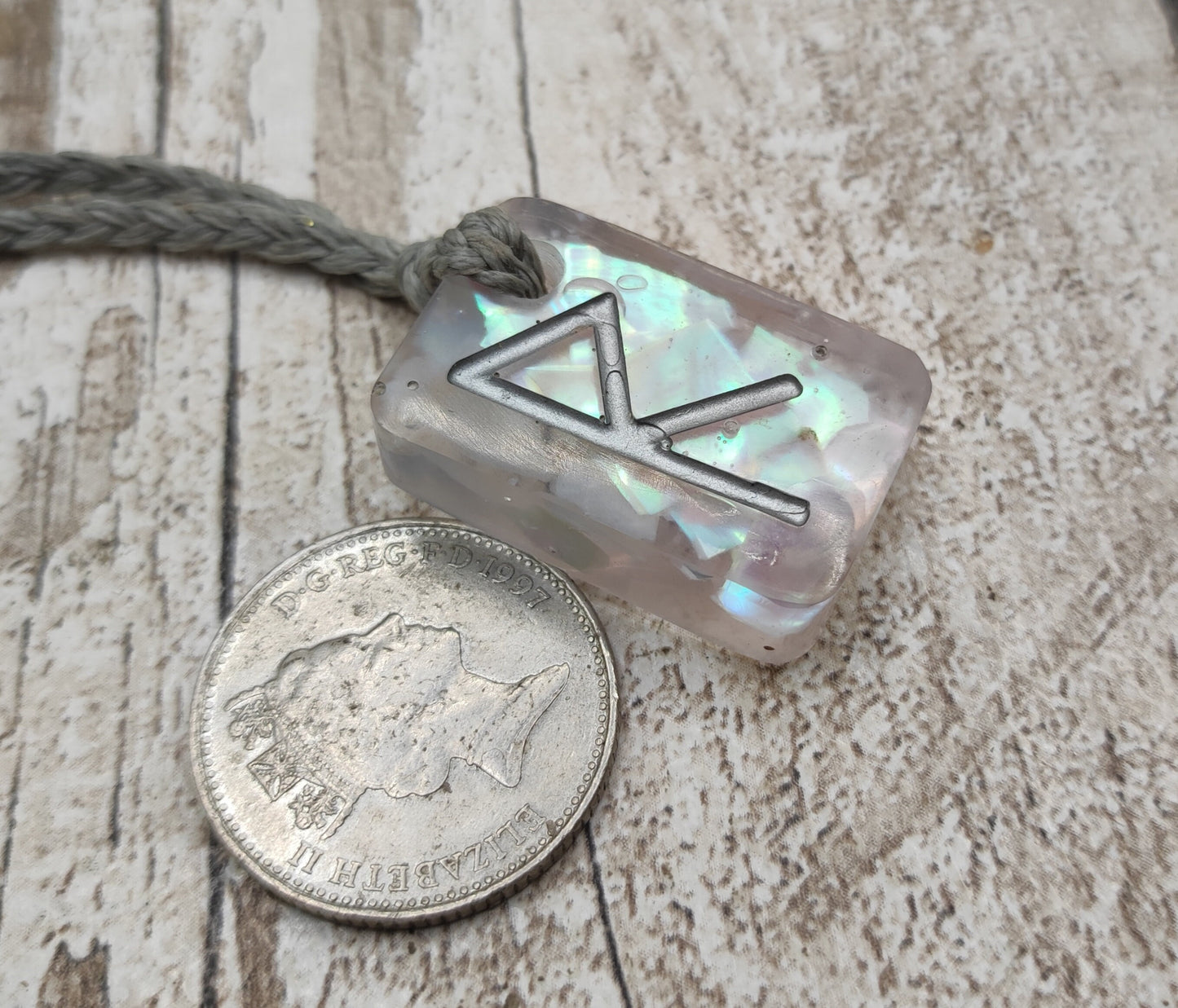 Raido rune pendant with UV resin and mussel shell.