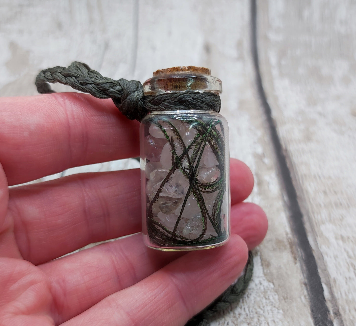 Clear quartz and peacock feather bottle pendant.