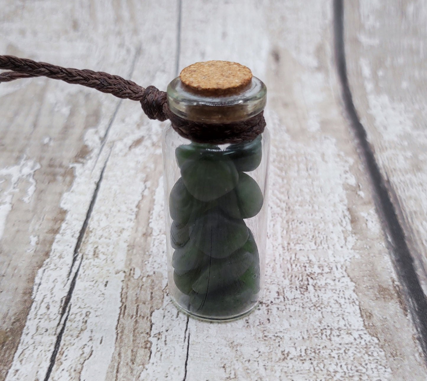 Nephrite jade chips in bottle pendant.