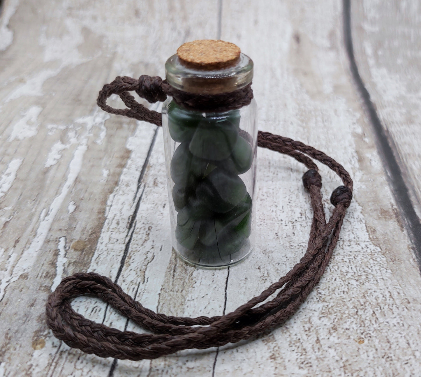 Nephrite jade chips in bottle pendant.