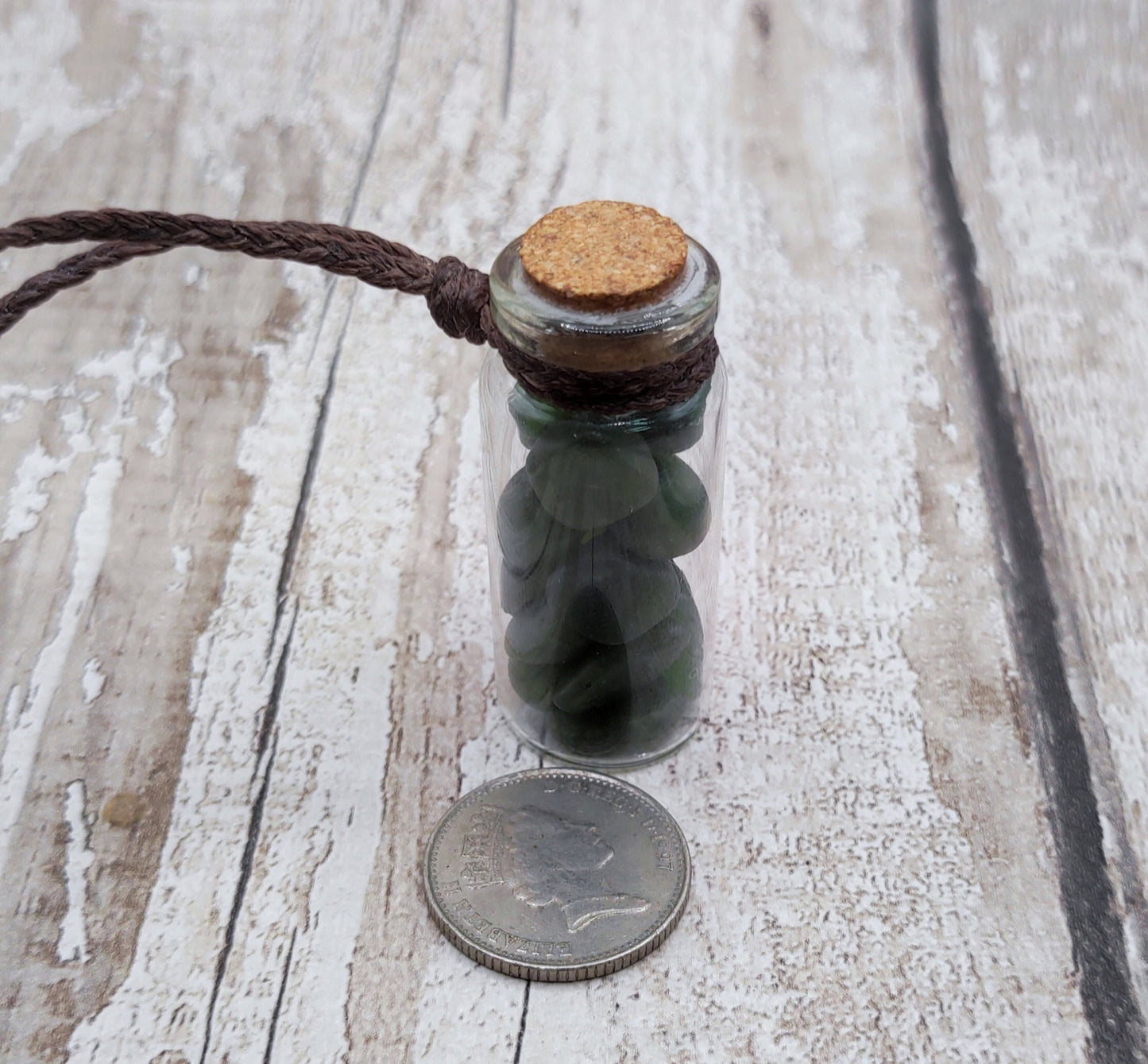 Nephrite jade chips in bottle pendant.