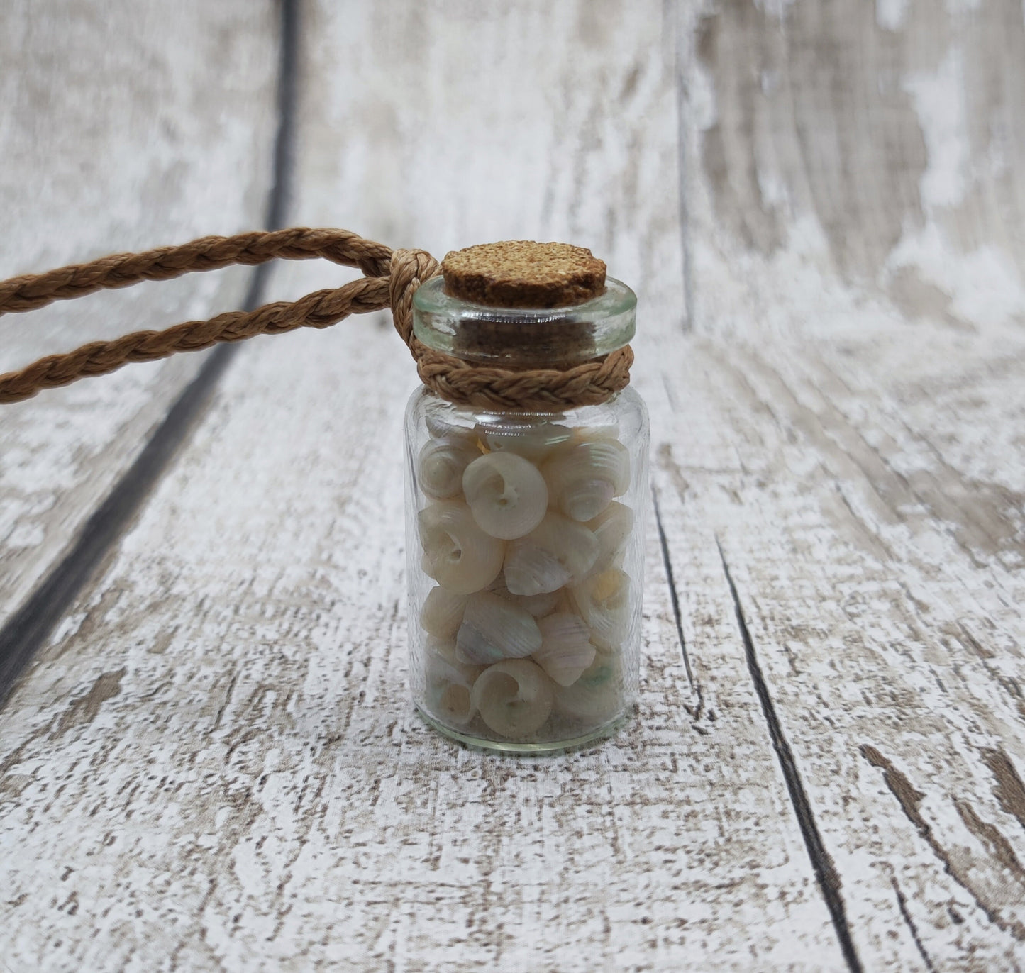 White shell filled bottle pendant.