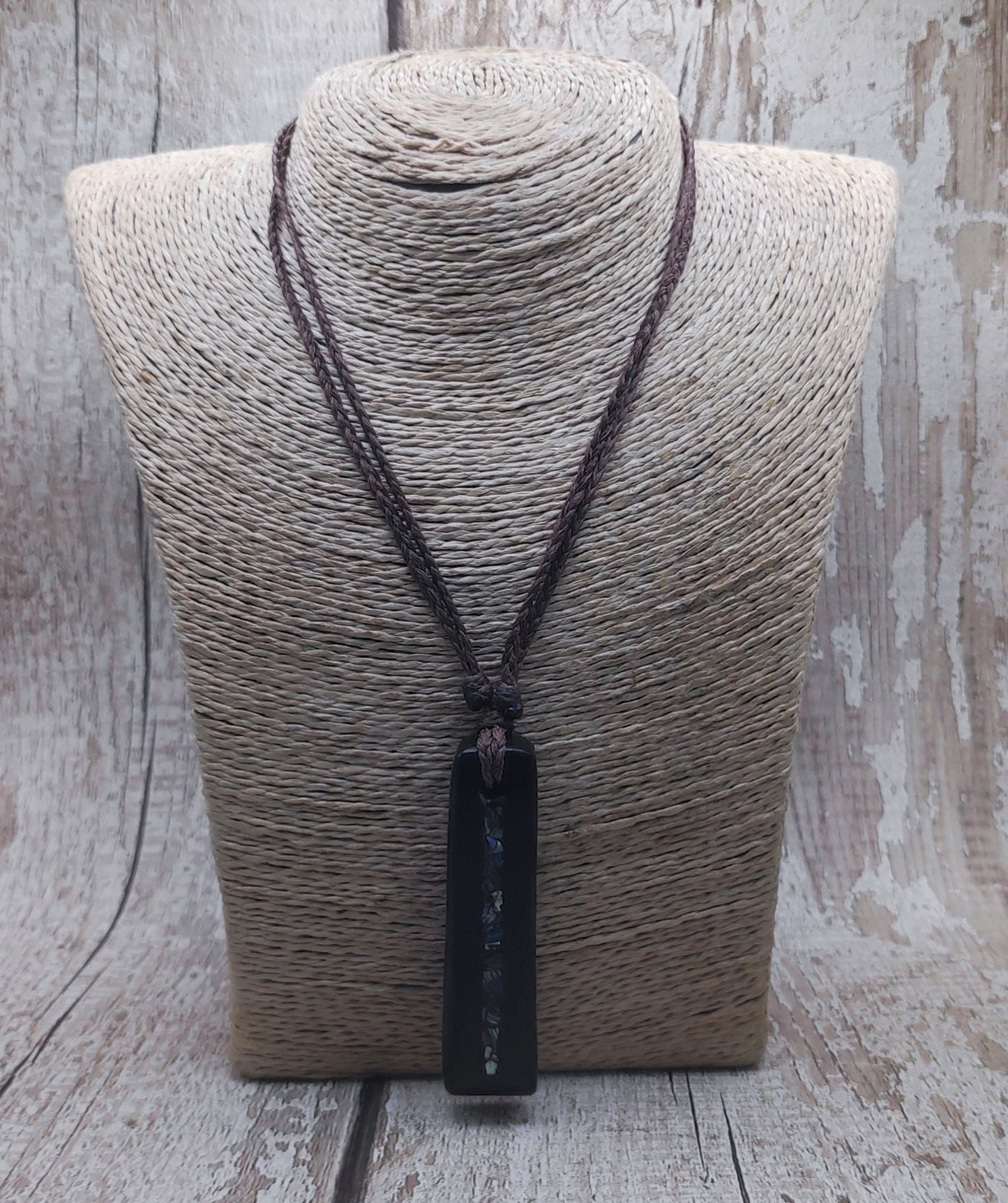 Bog oak and NZ rainbow pāua shell toki pendant.