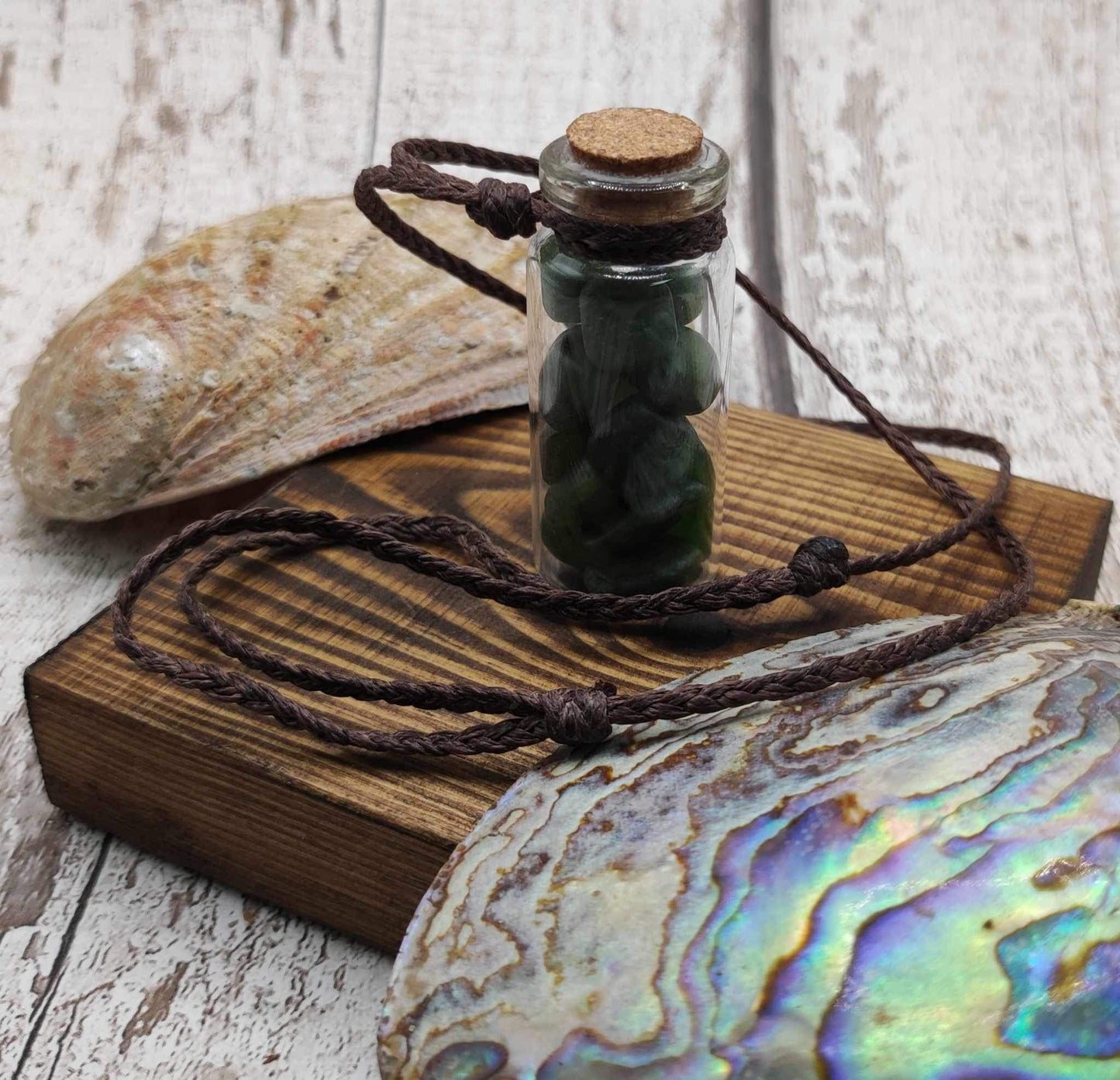 Nephrite jade chips in bottle pendant.