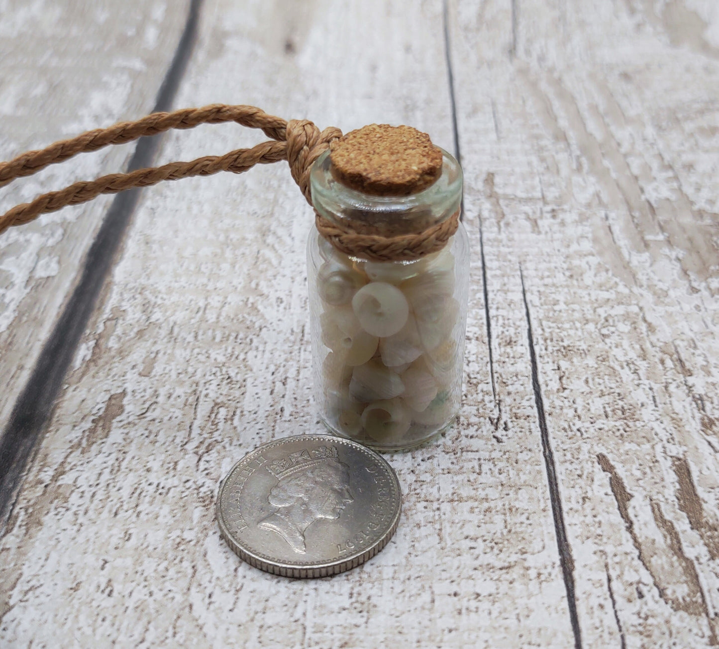 White shell filled bottle pendant.