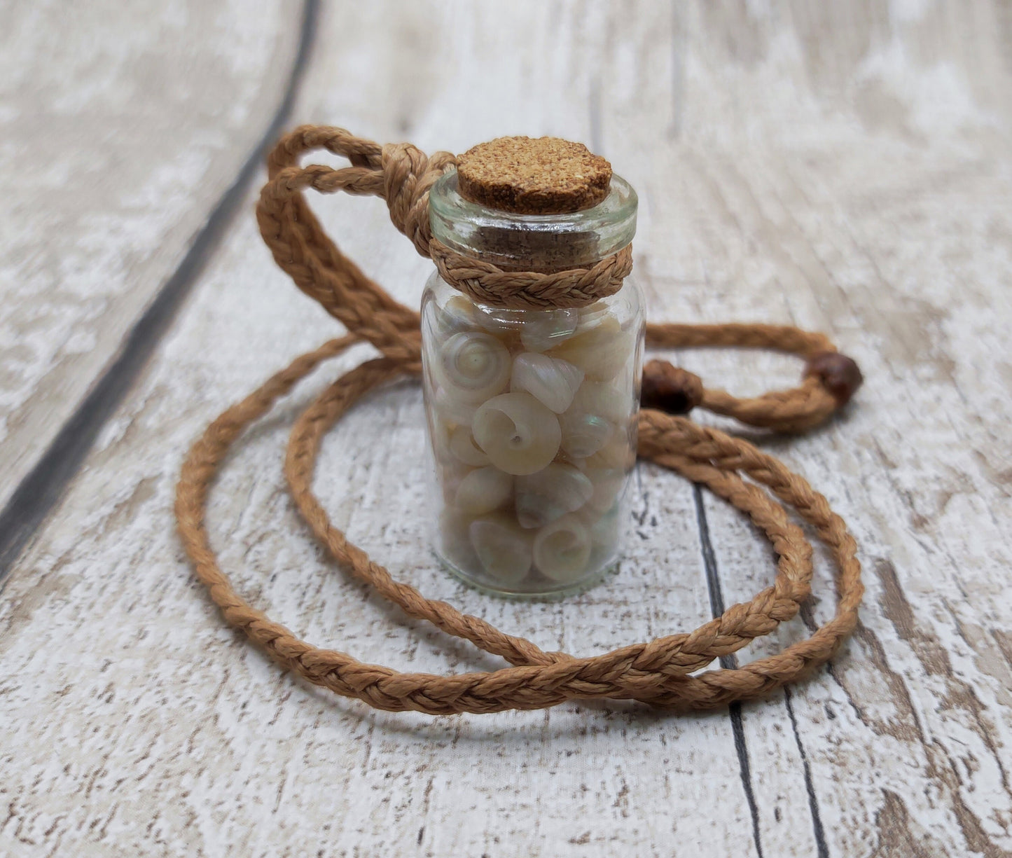 White shell filled bottle pendant.