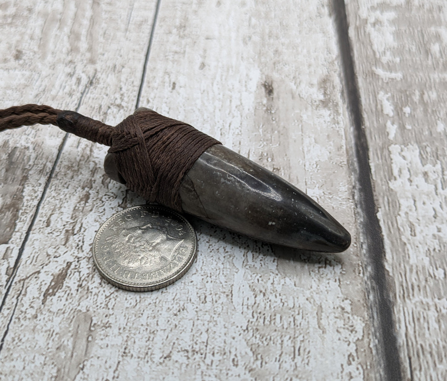 Belemnite fossil hei toki adze pendant.