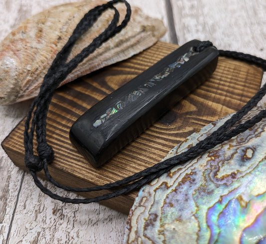 Bog oak and NZ rainbow pāua shell toki pendant.