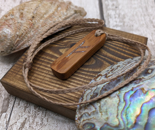 Fehu scottish yew wood rune pendant with abalone shell.